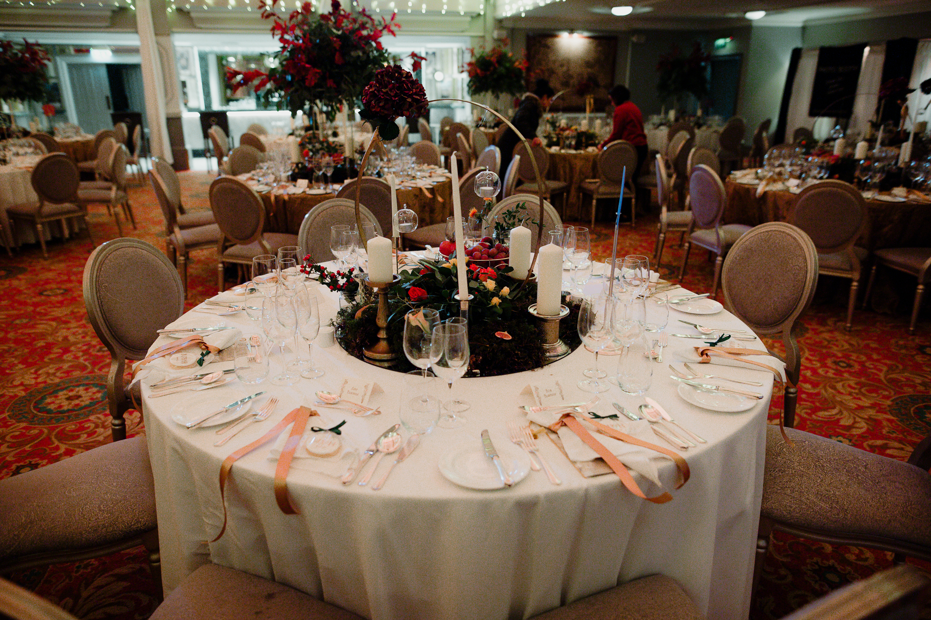 A dining table with candles and glasses