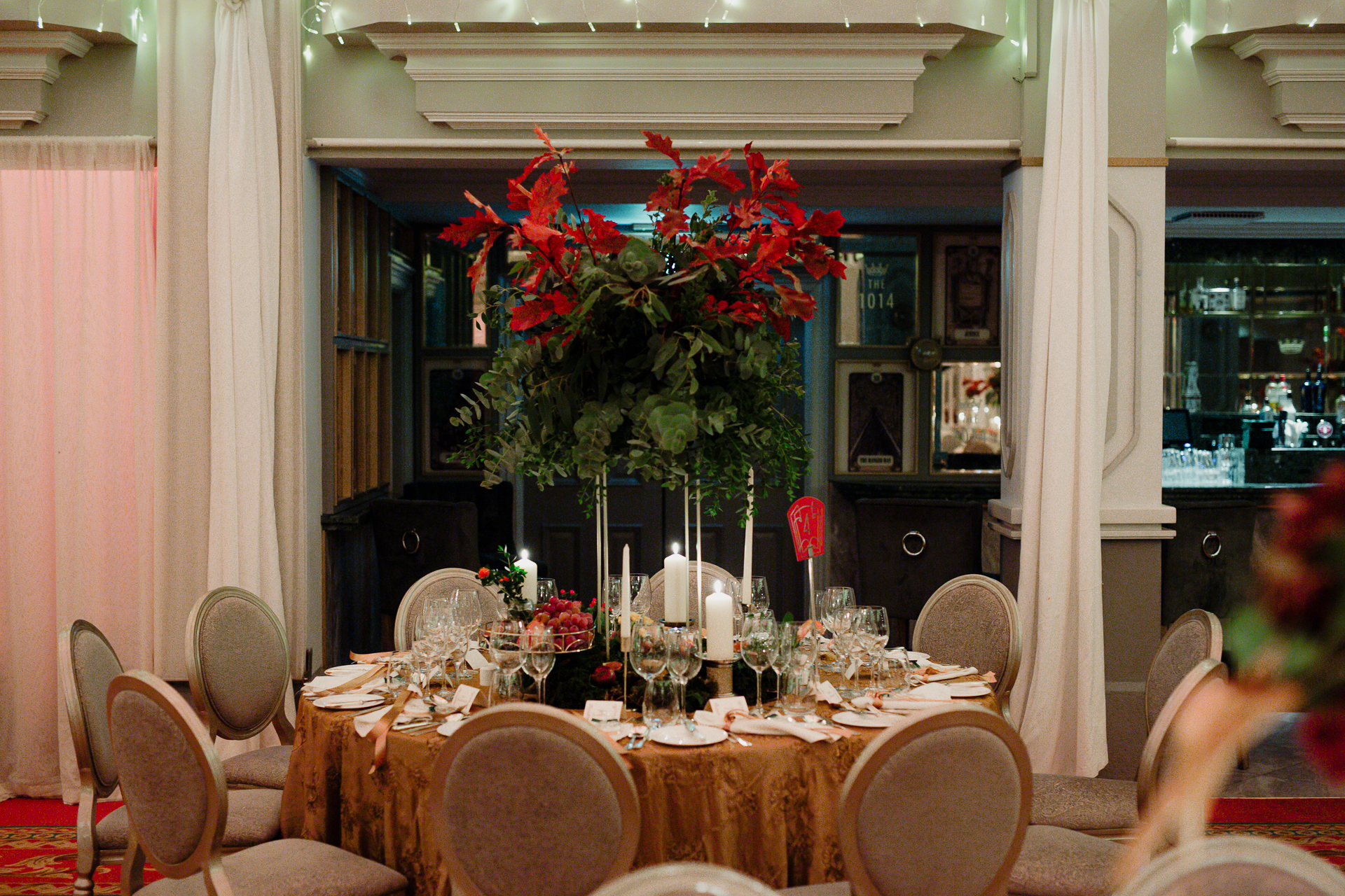 A dining table with a large wreath on it