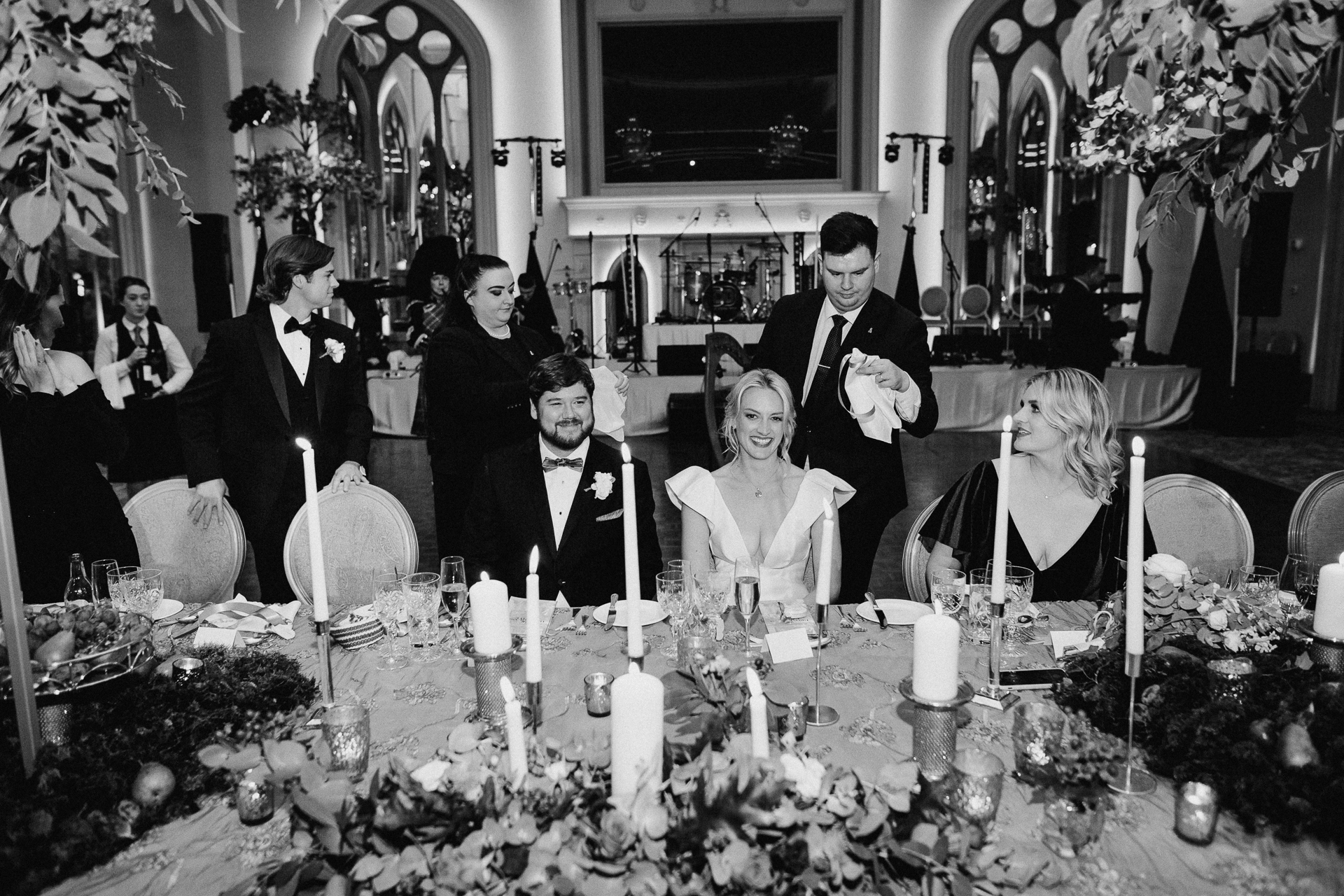 A group of people sitting at a table with candles