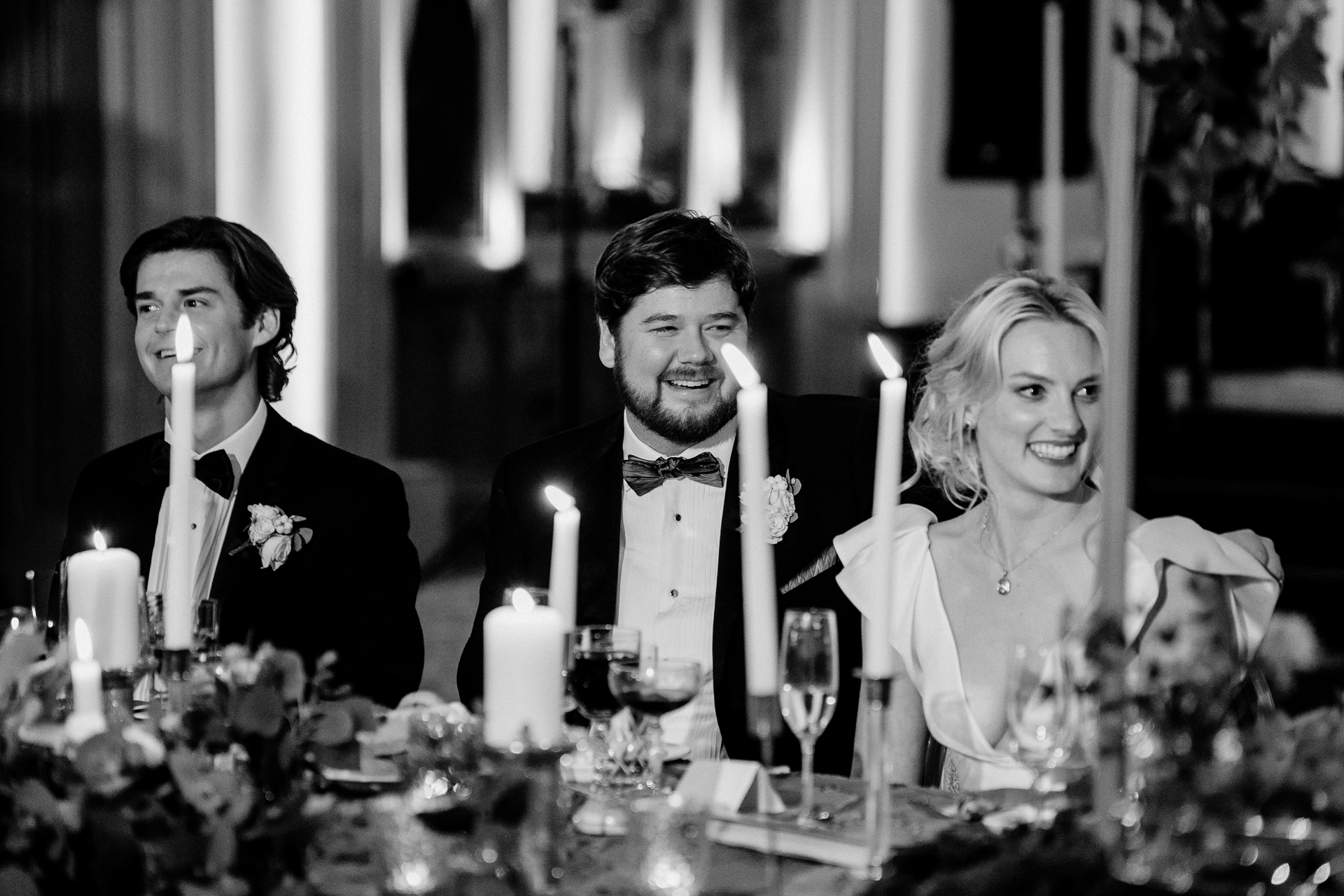 A bride and groom sitting at a table with a couple of women