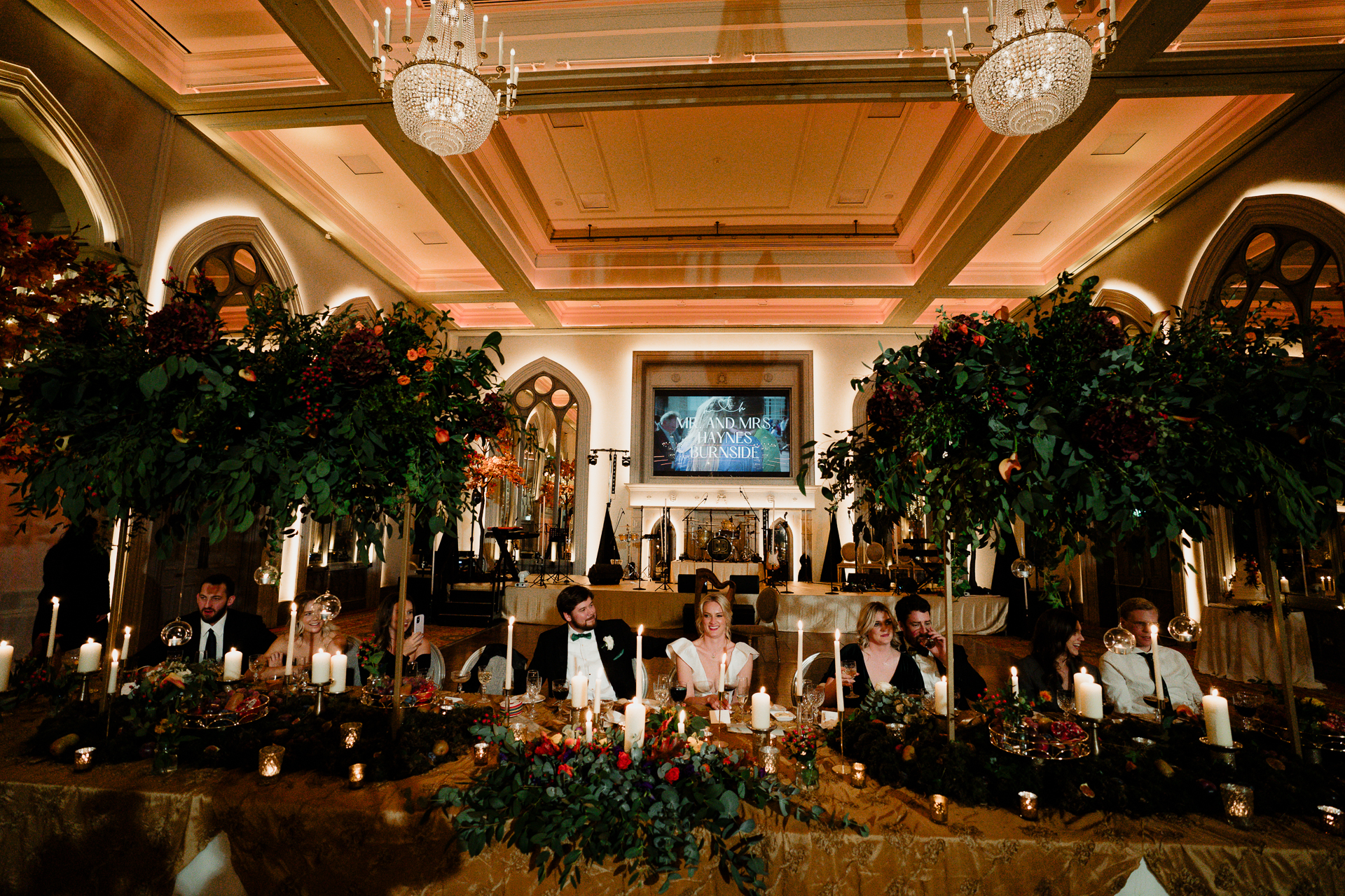 A group of people sitting at a table with flowers