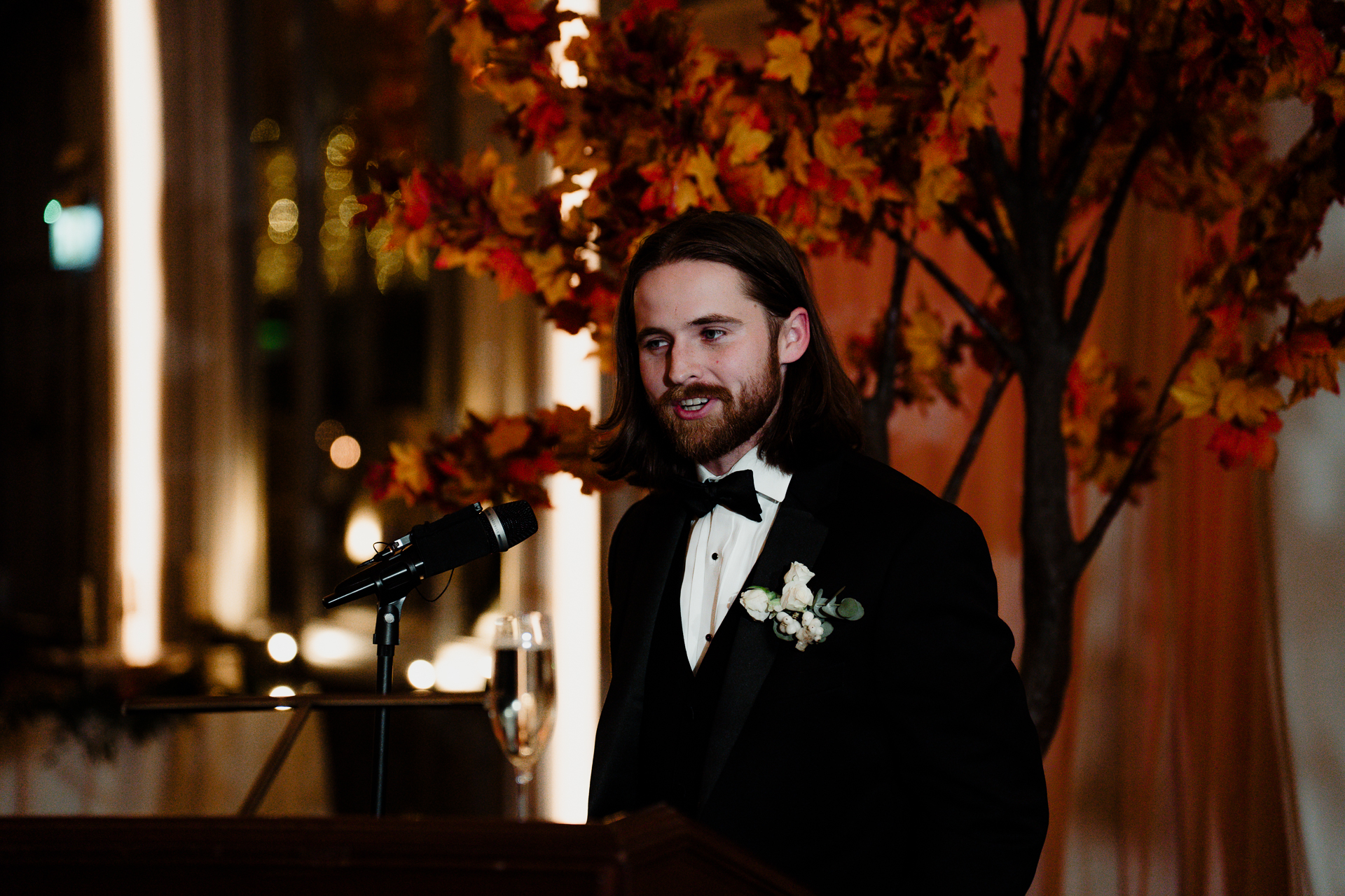 A man in a tuxedo at a podium