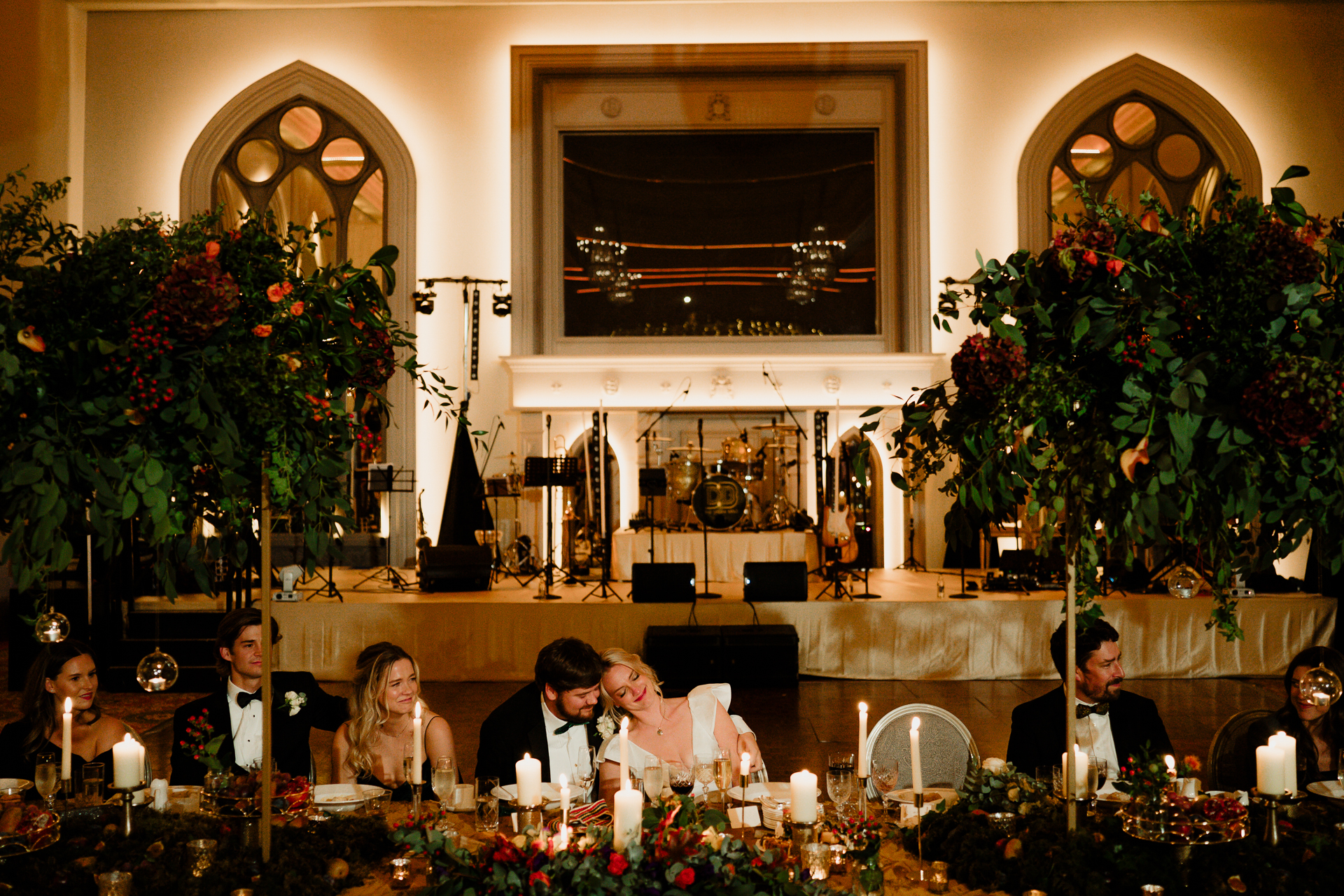 A group of people sitting at a table with candles