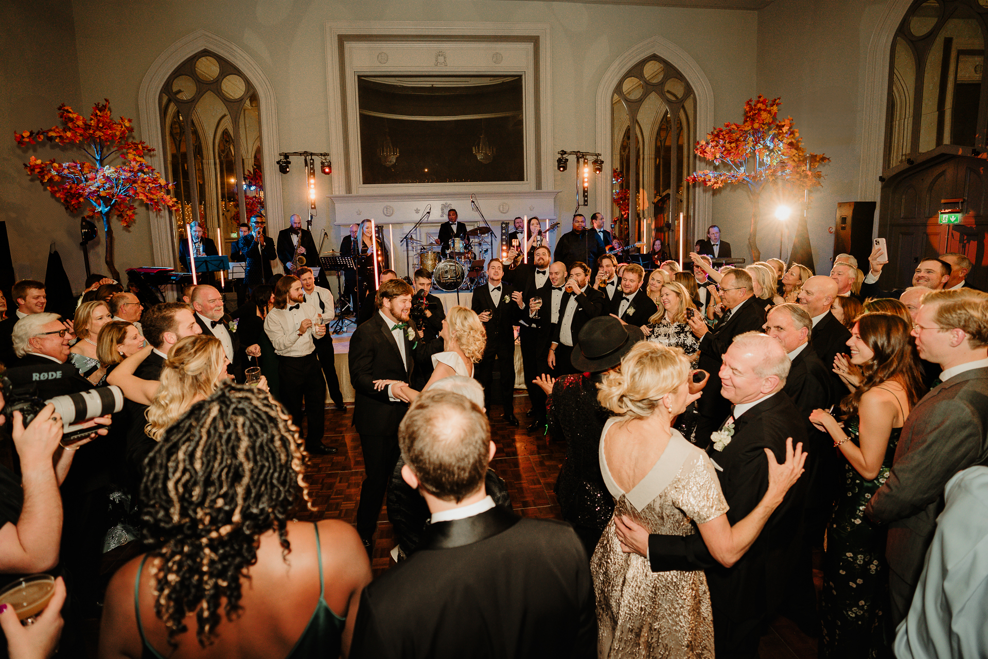 A group of people dancing in a room with a large group of people