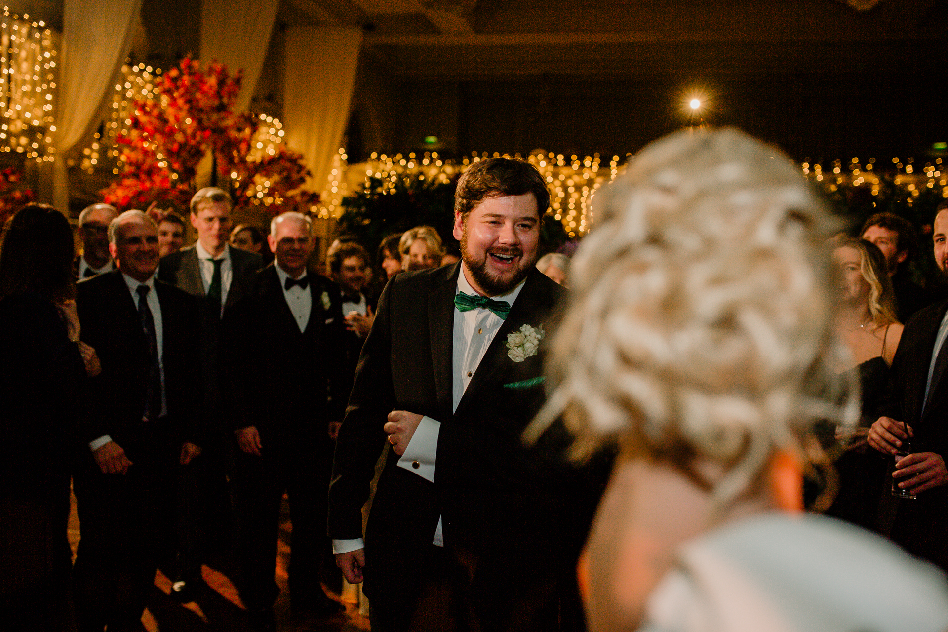 A man in a suit laughing