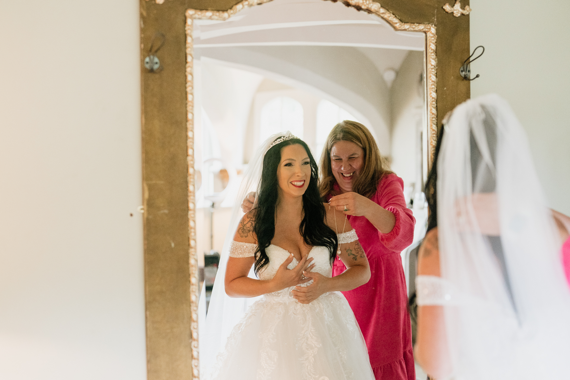 A person in a white dress and a person in a red dress