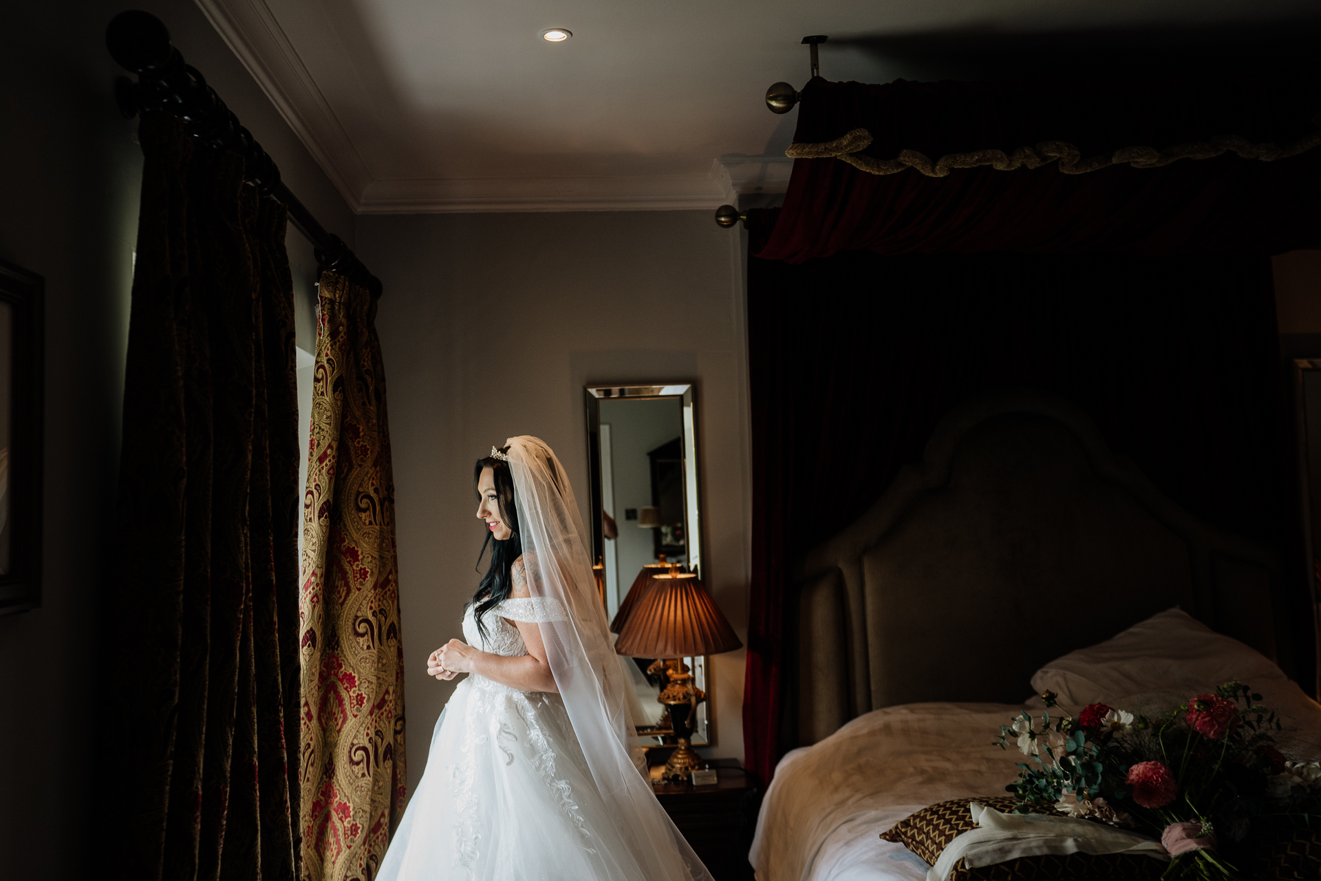 A person in a wedding dress in a bedroom