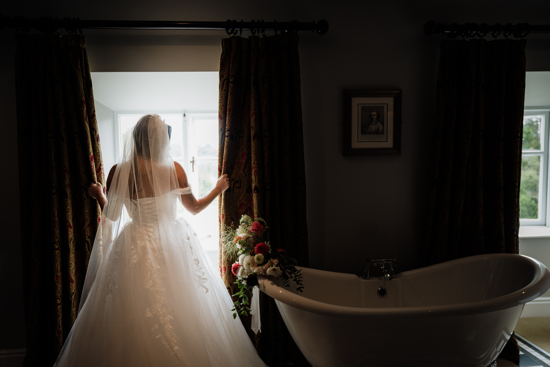 A person in a wedding dress in a bathroom