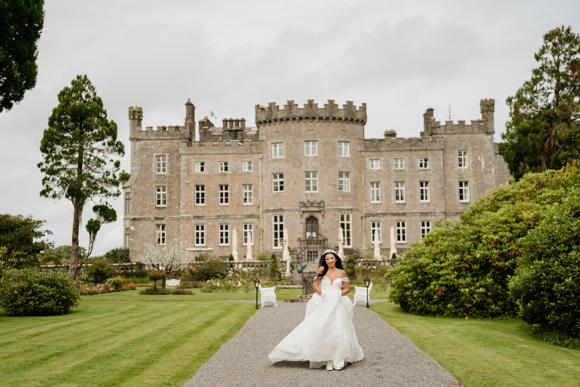 A person in a wedding dress in front of a large building