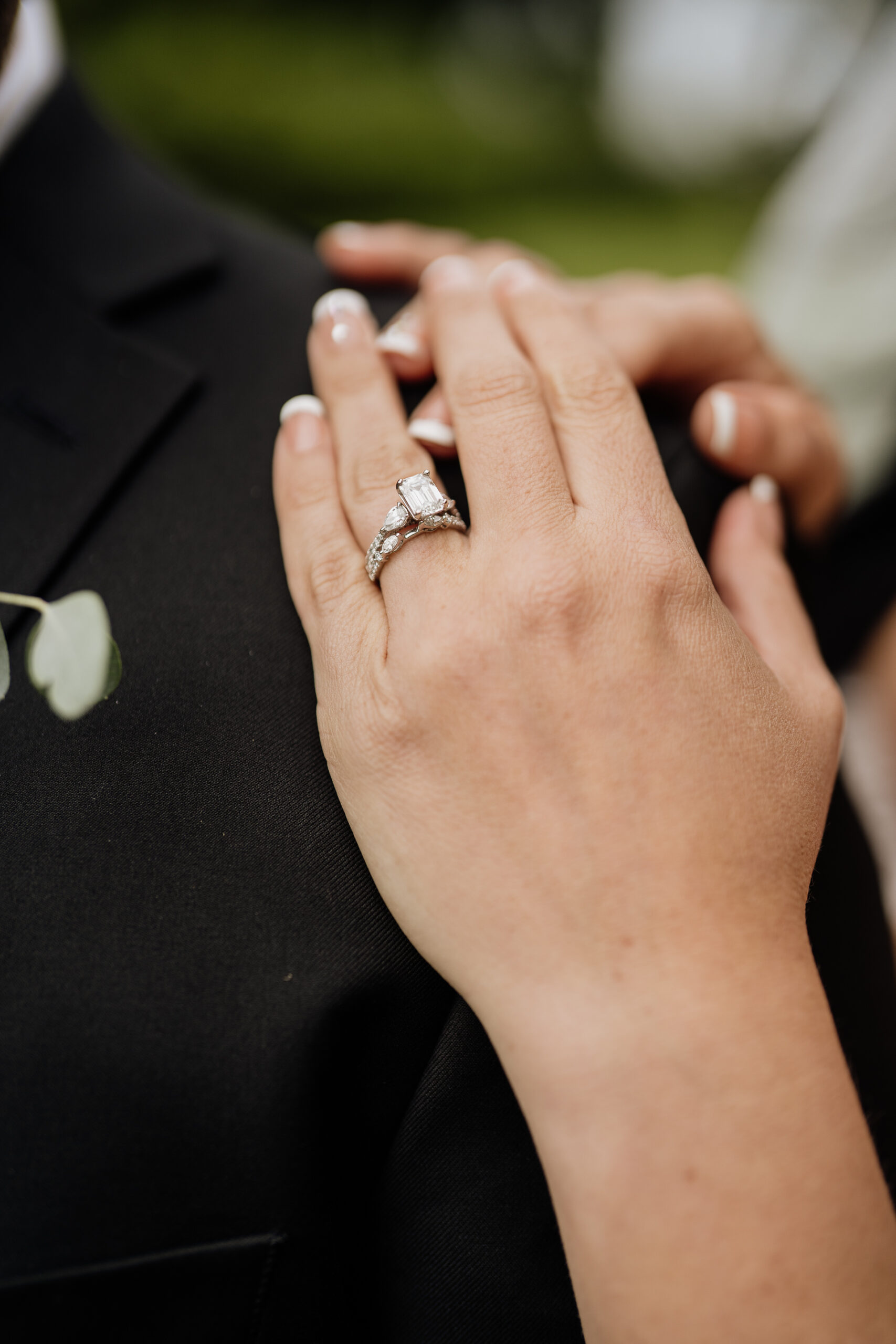 A person's hand with a wedding ring on it