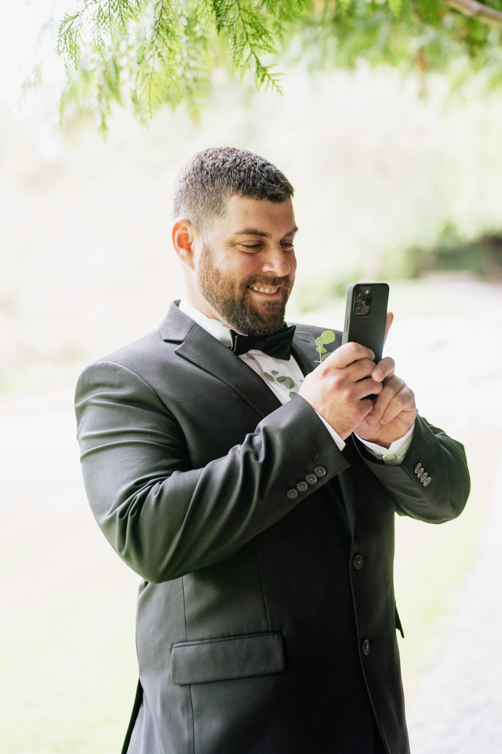 A man in a suit holding a phone