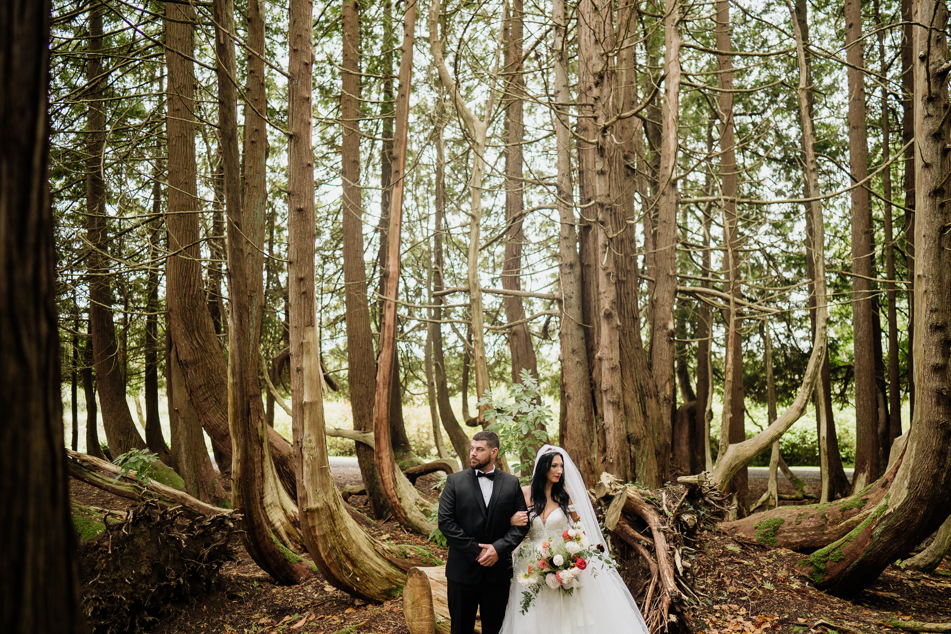 A bride and groom in a forest