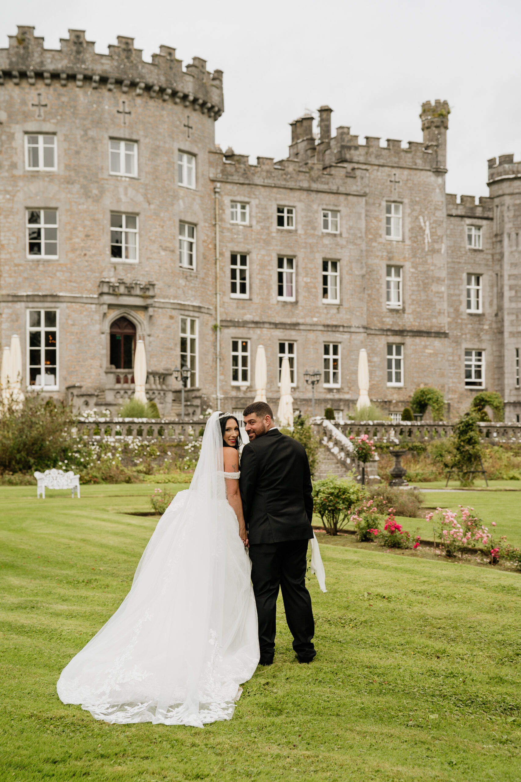 A man and woman in front of a large building