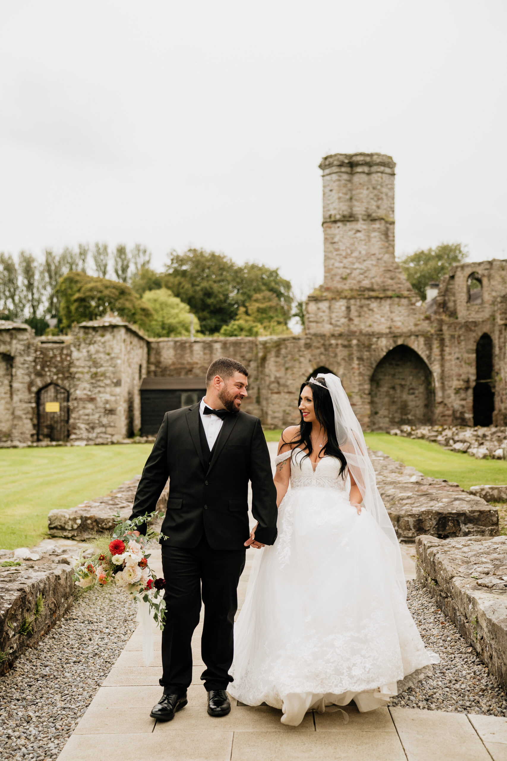 A man and woman posing for a picture in front of a castle