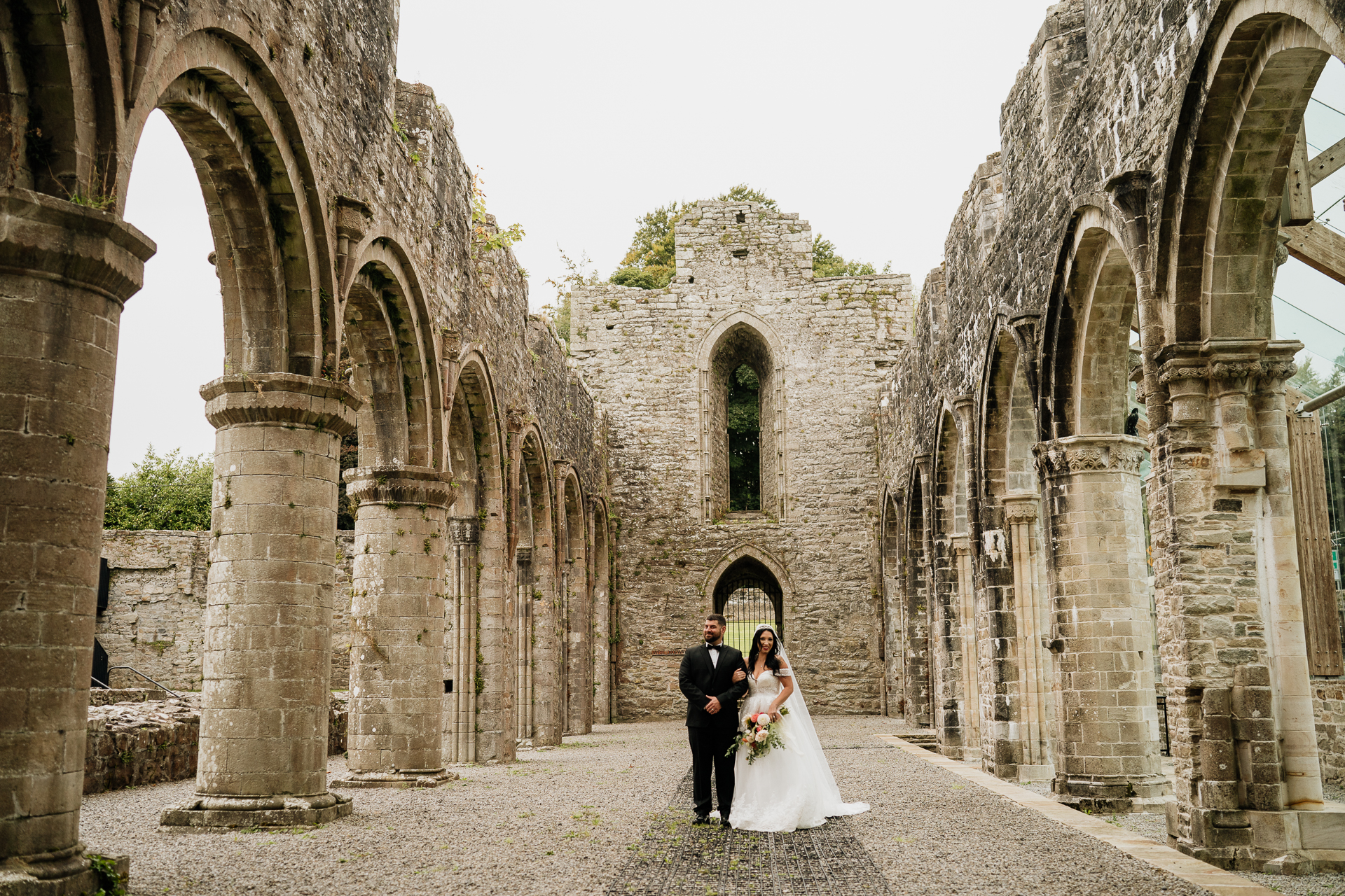 A man and woman in a stone building with arches and columns