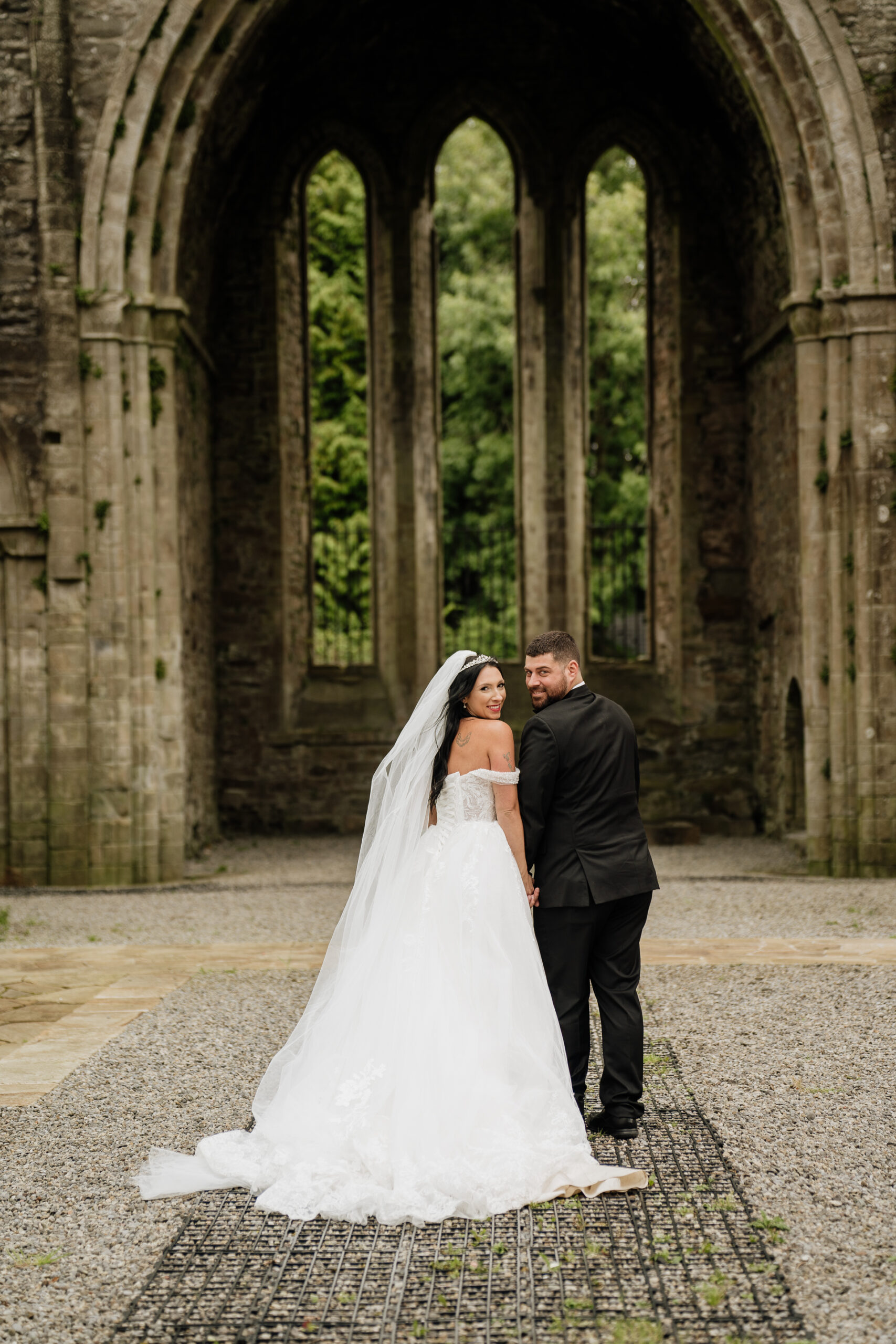 A man and woman in a large stone building with arches and columns