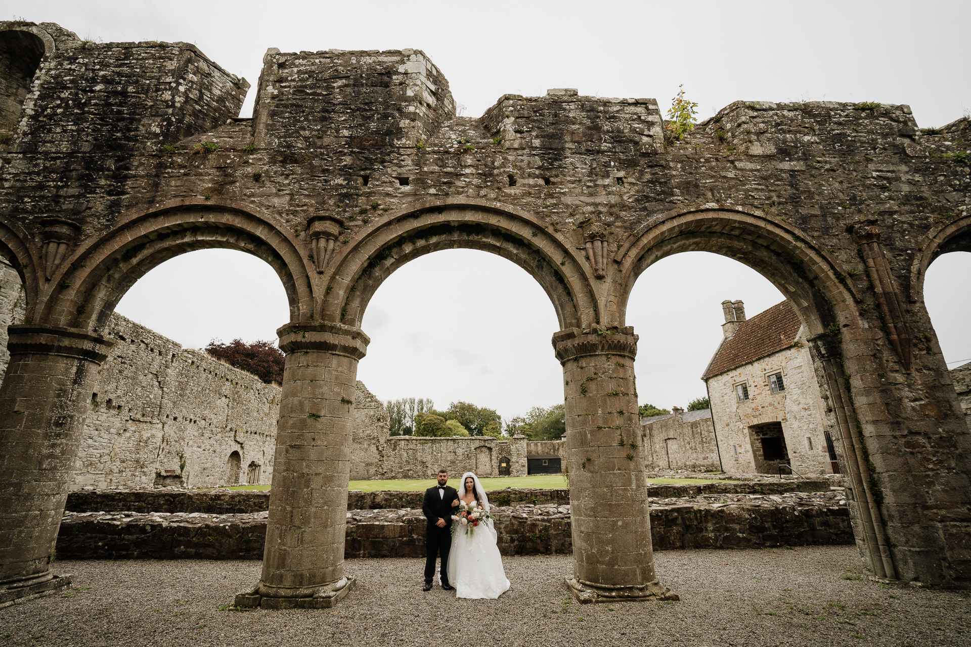 A couple standing in front of an old building