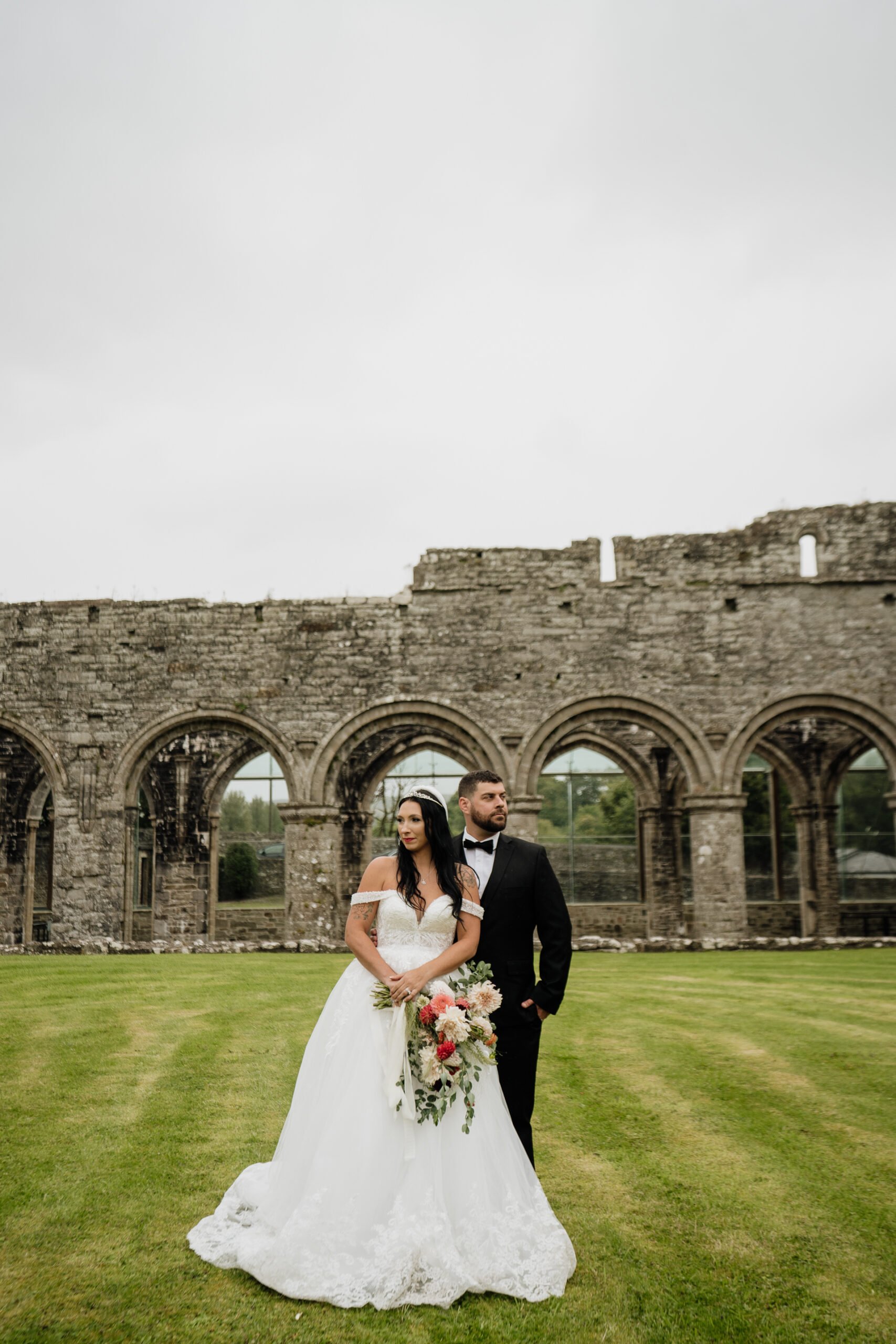 A man and woman posing for a picture in front of a building