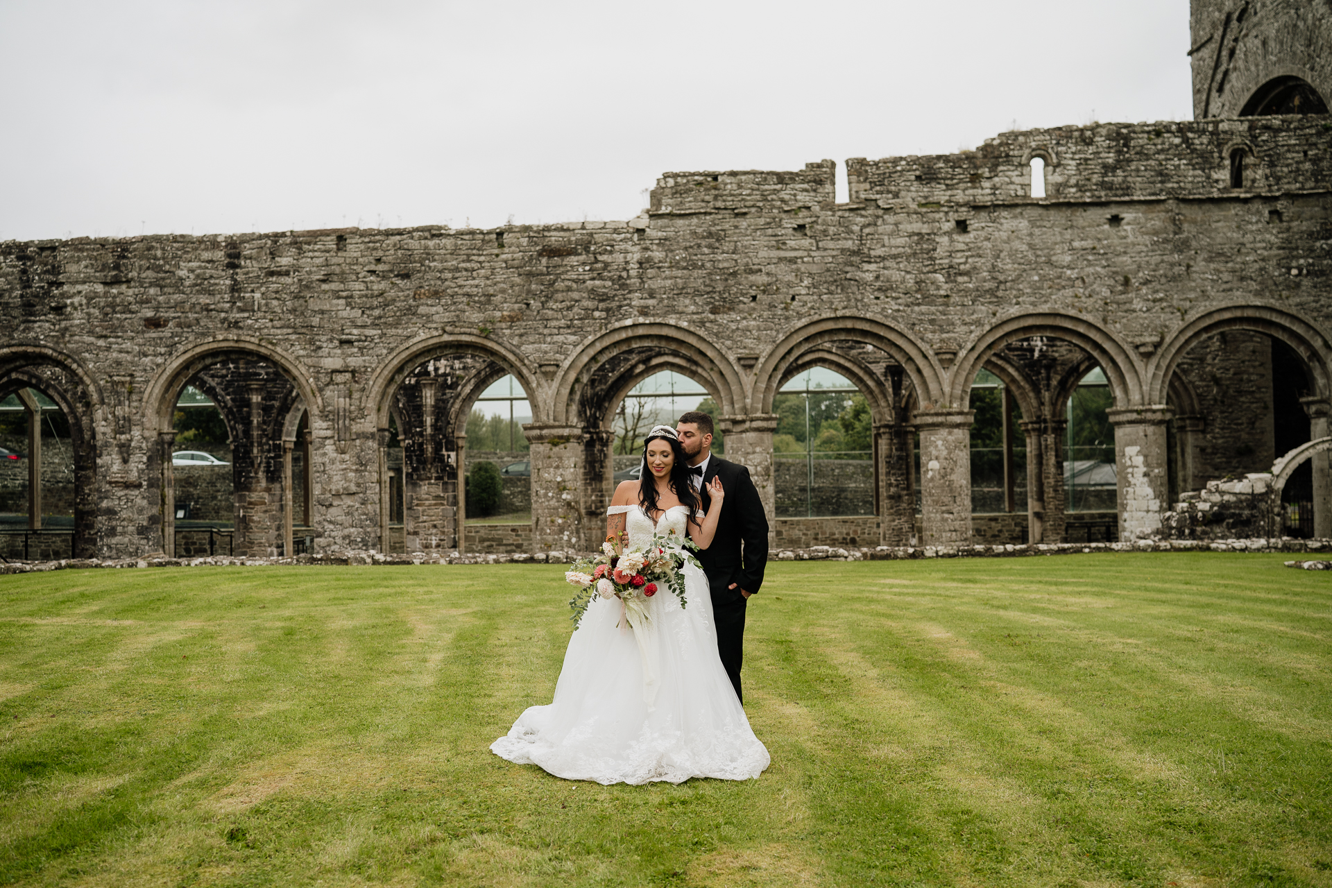 A man and woman in front of a stone building