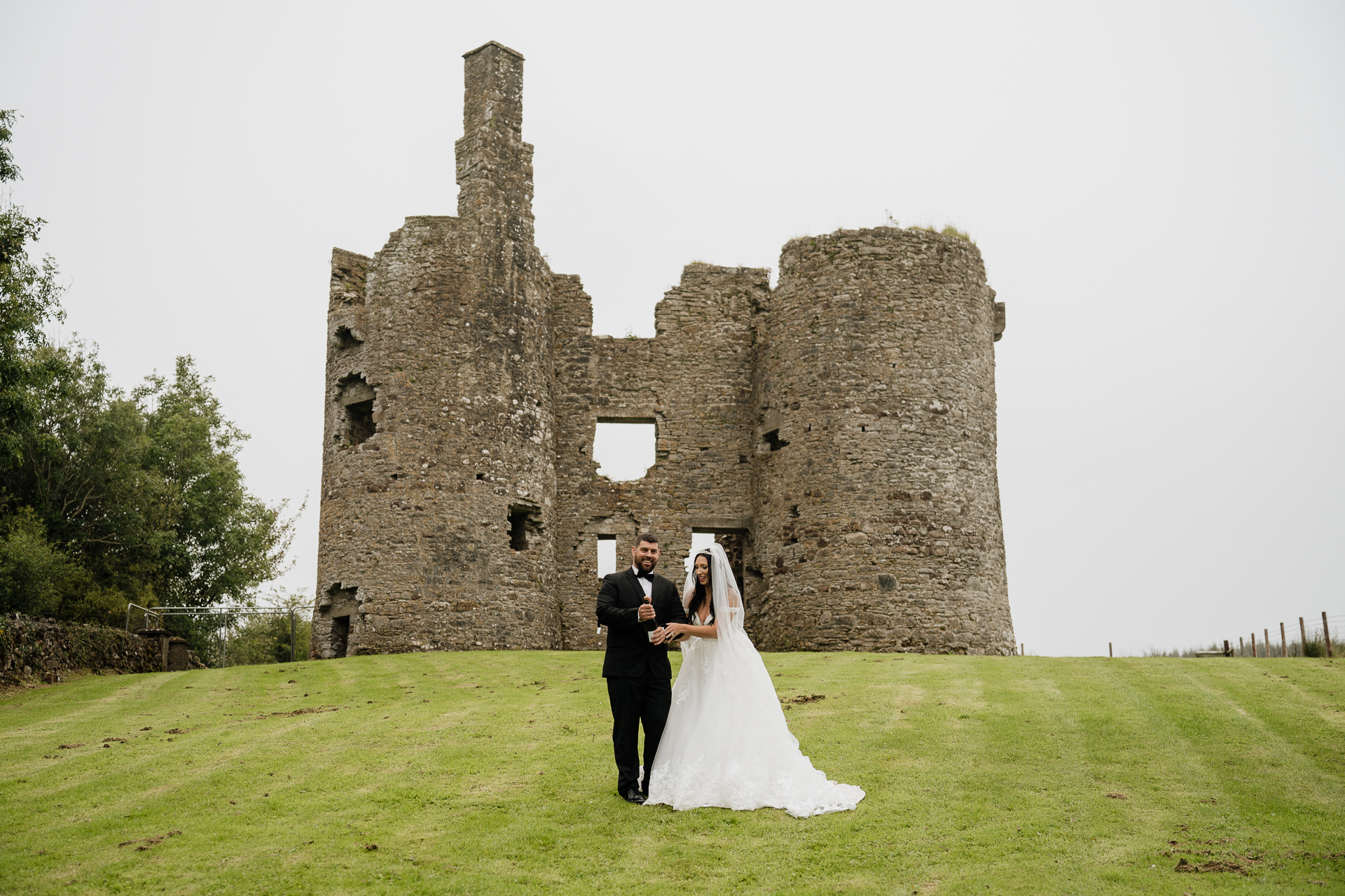 A man and woman in front of a castle