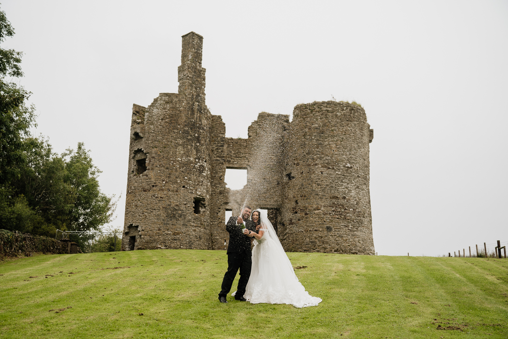 A man and woman in front of a castle