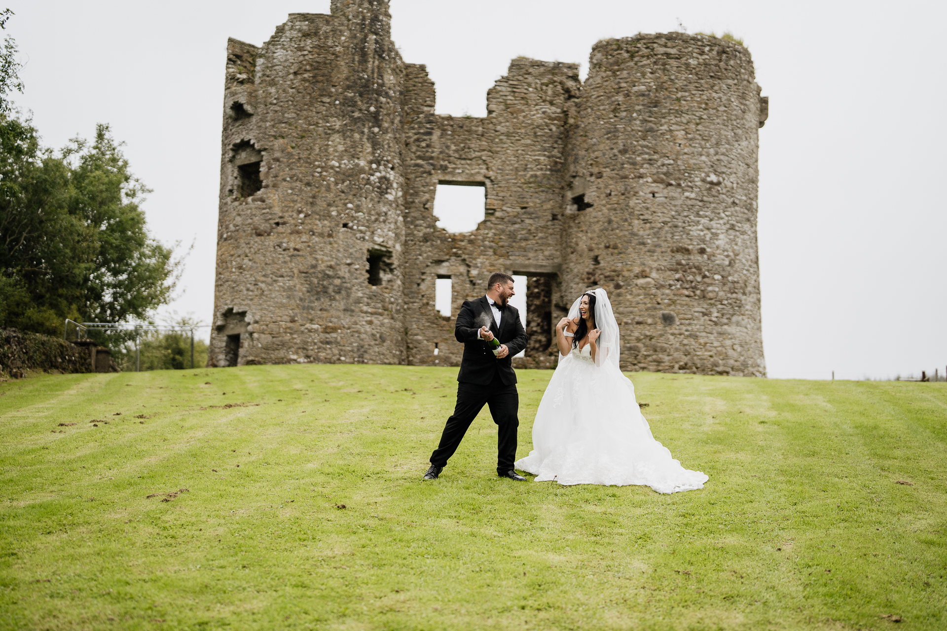 A man and woman in front of a stone building