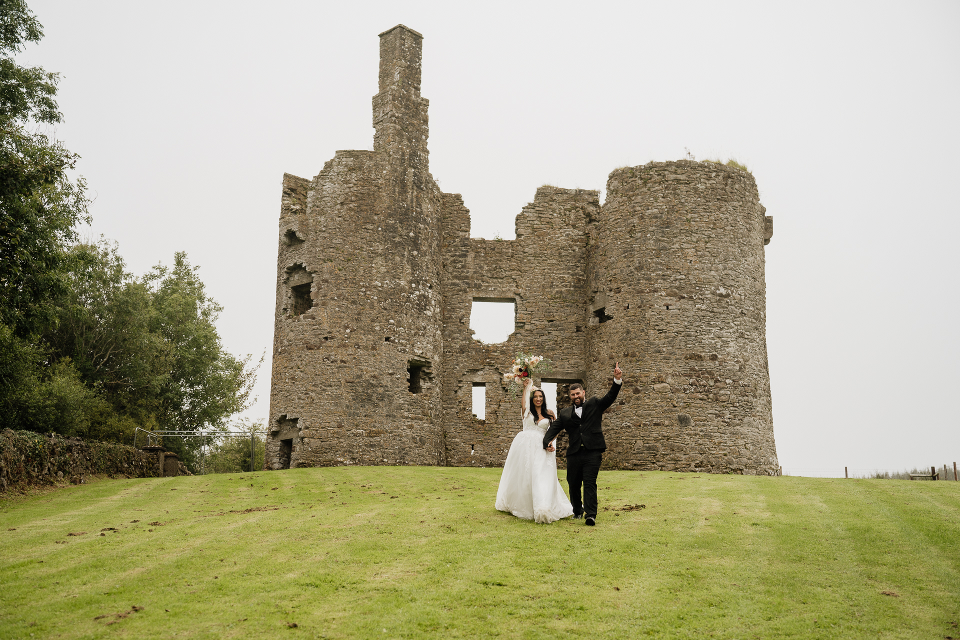 A man and woman in front of a castle