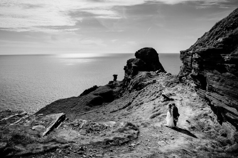 A couple people on a rocky beach