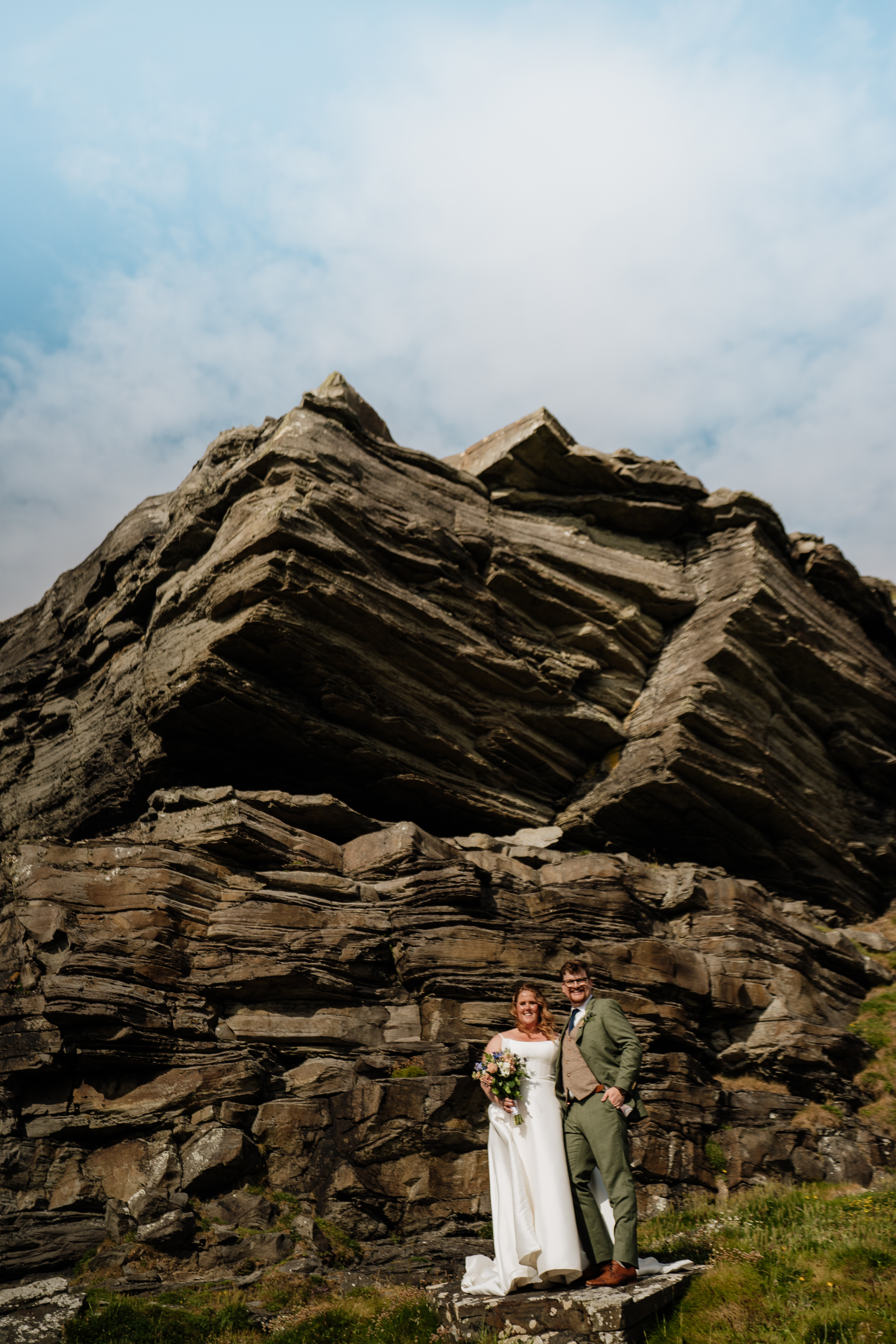 A man and woman standing in front of a rock formation