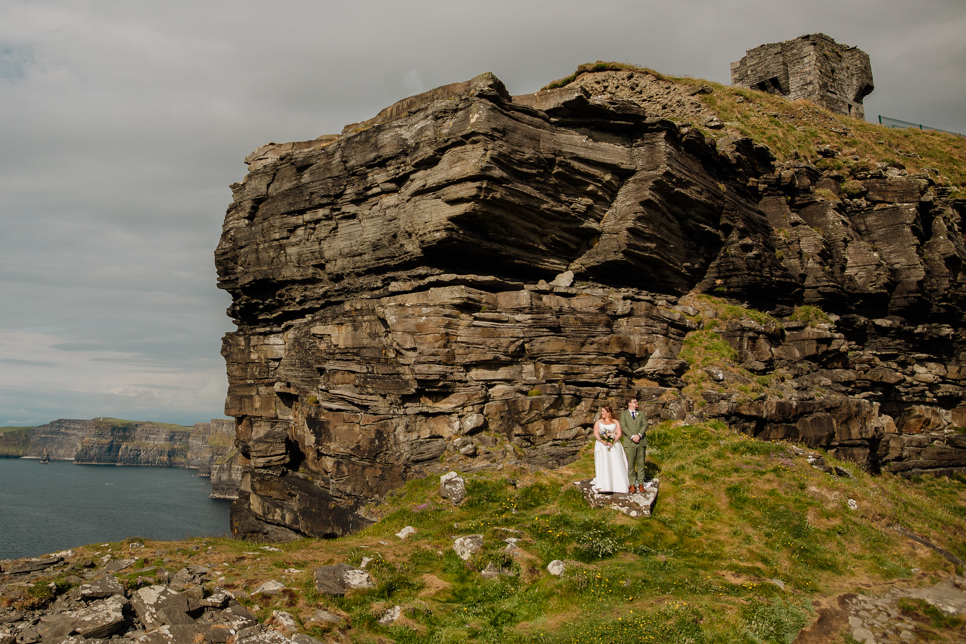 A couple standing in front of a large rock formation