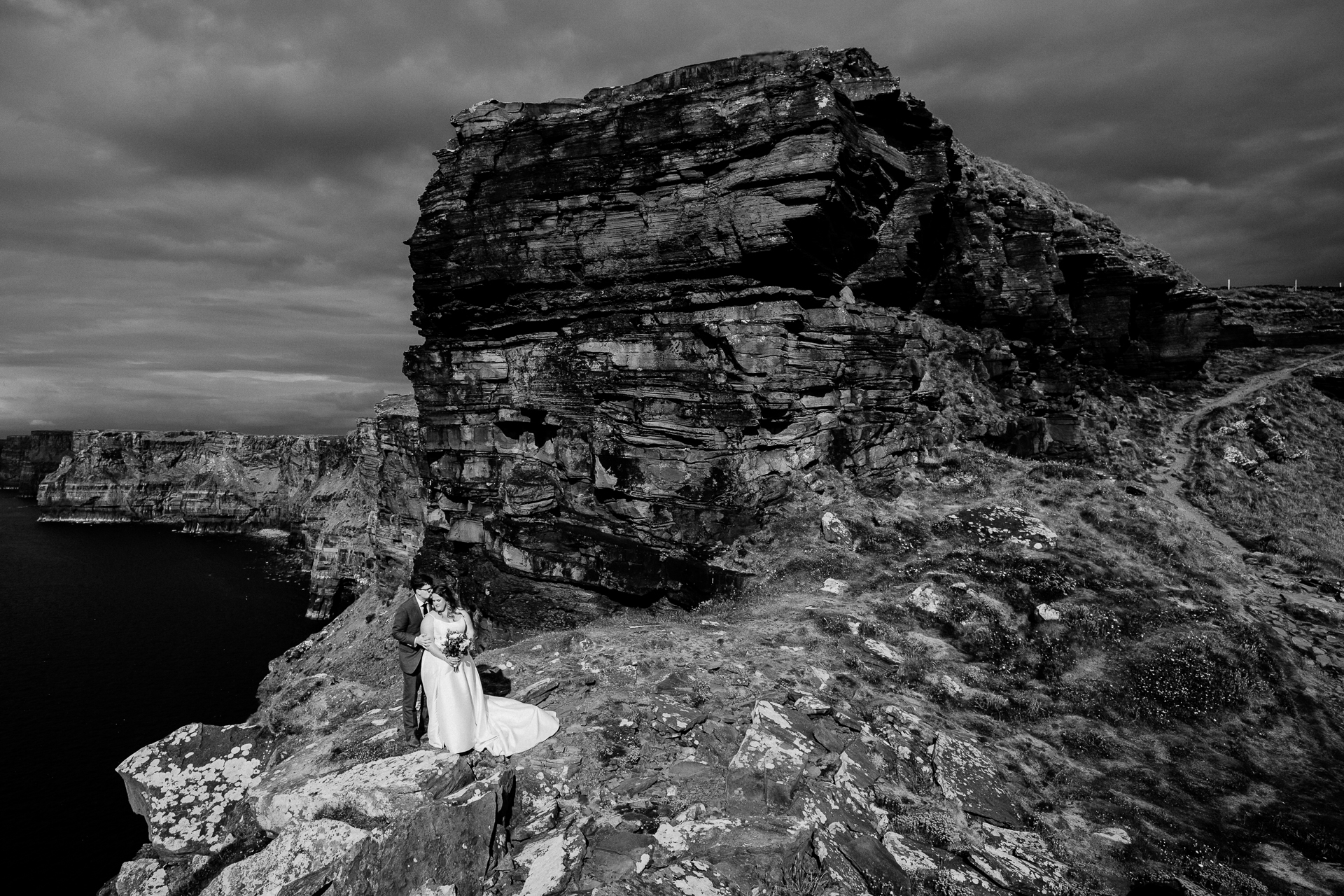 A couple standing on a rocky cliff