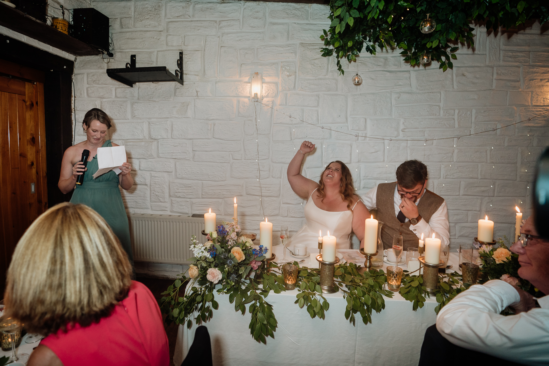 A group of people sitting around a table with candles