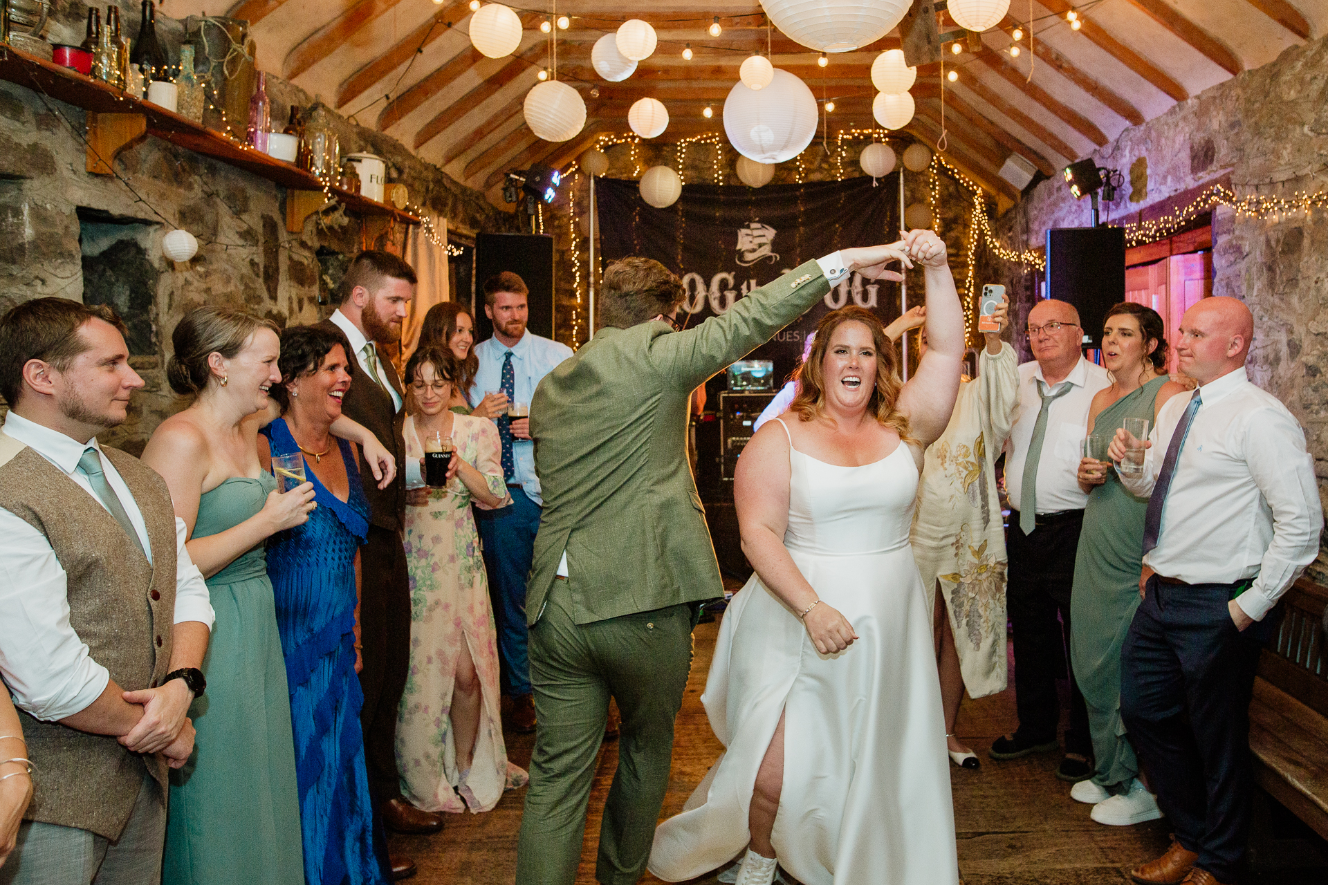 A man and woman dancing in a room full of people