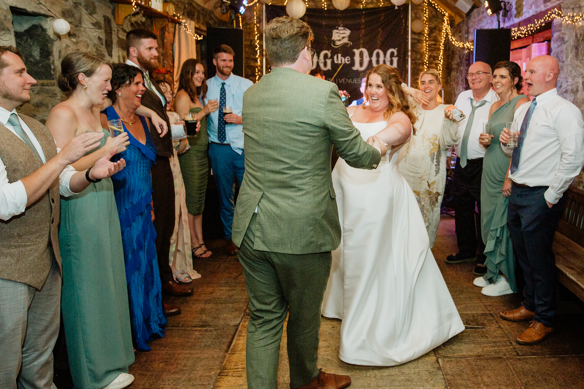 A man and woman dancing in a room full of people