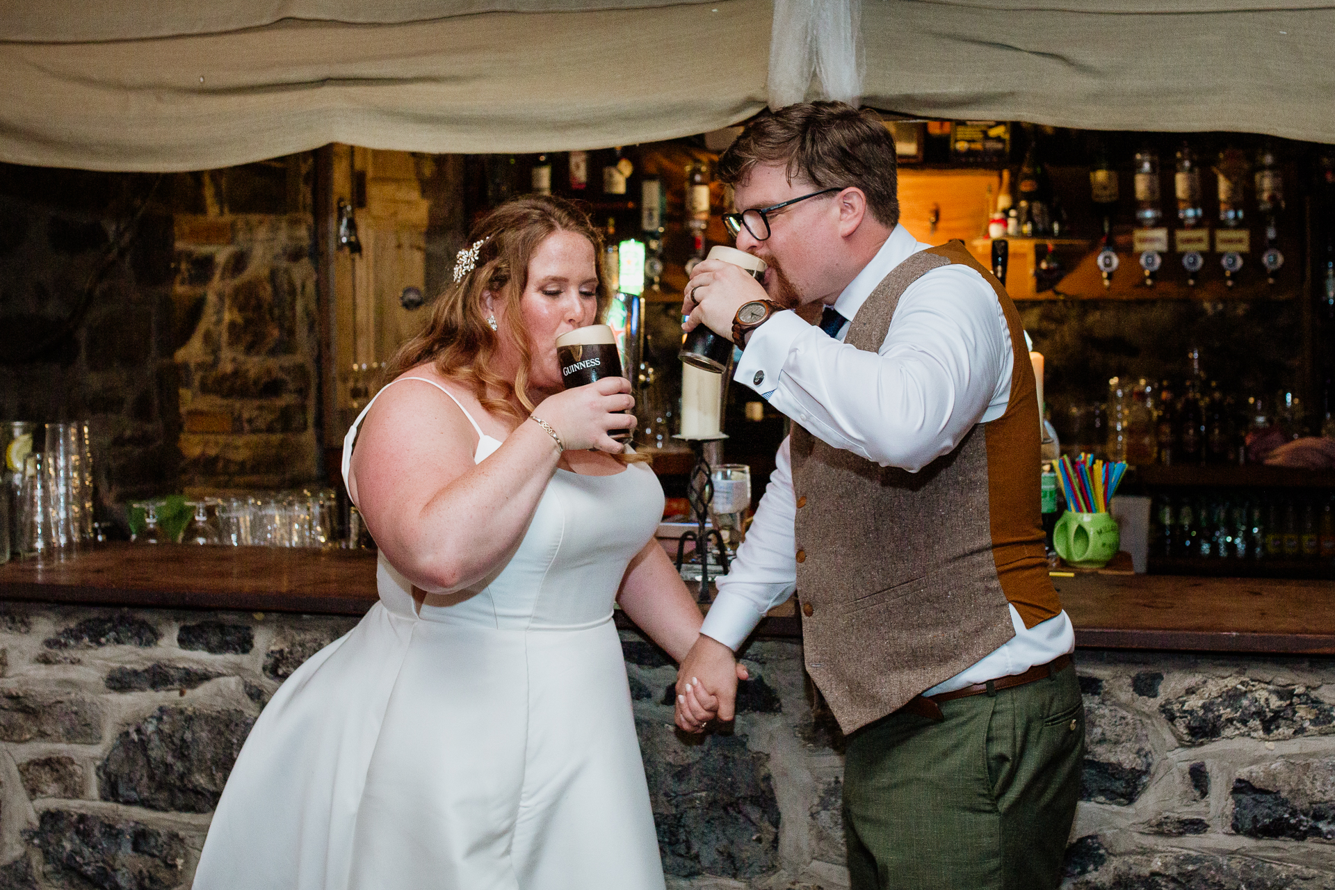 A man and woman holding glasses of beer