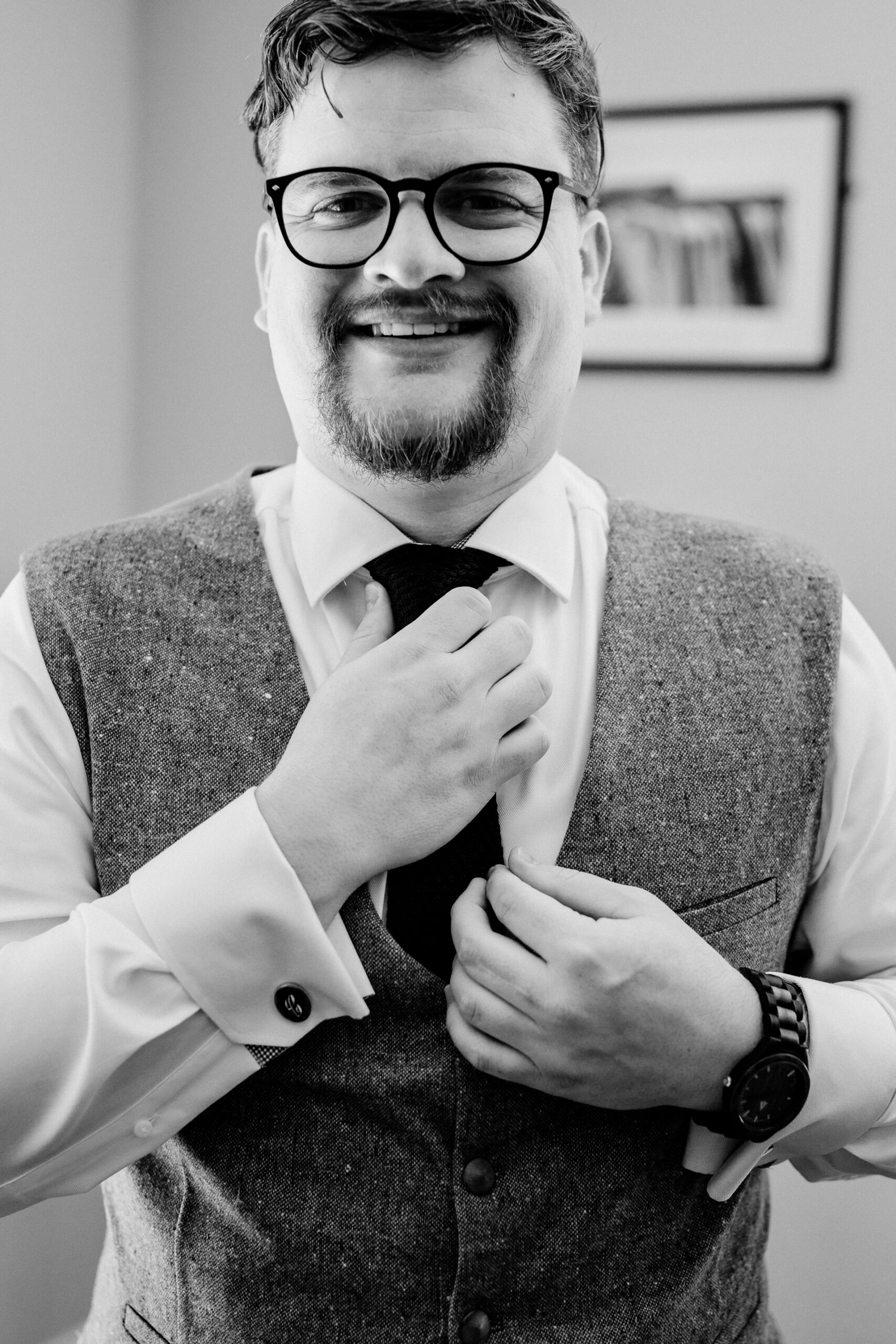 A man wearing glasses and a suit