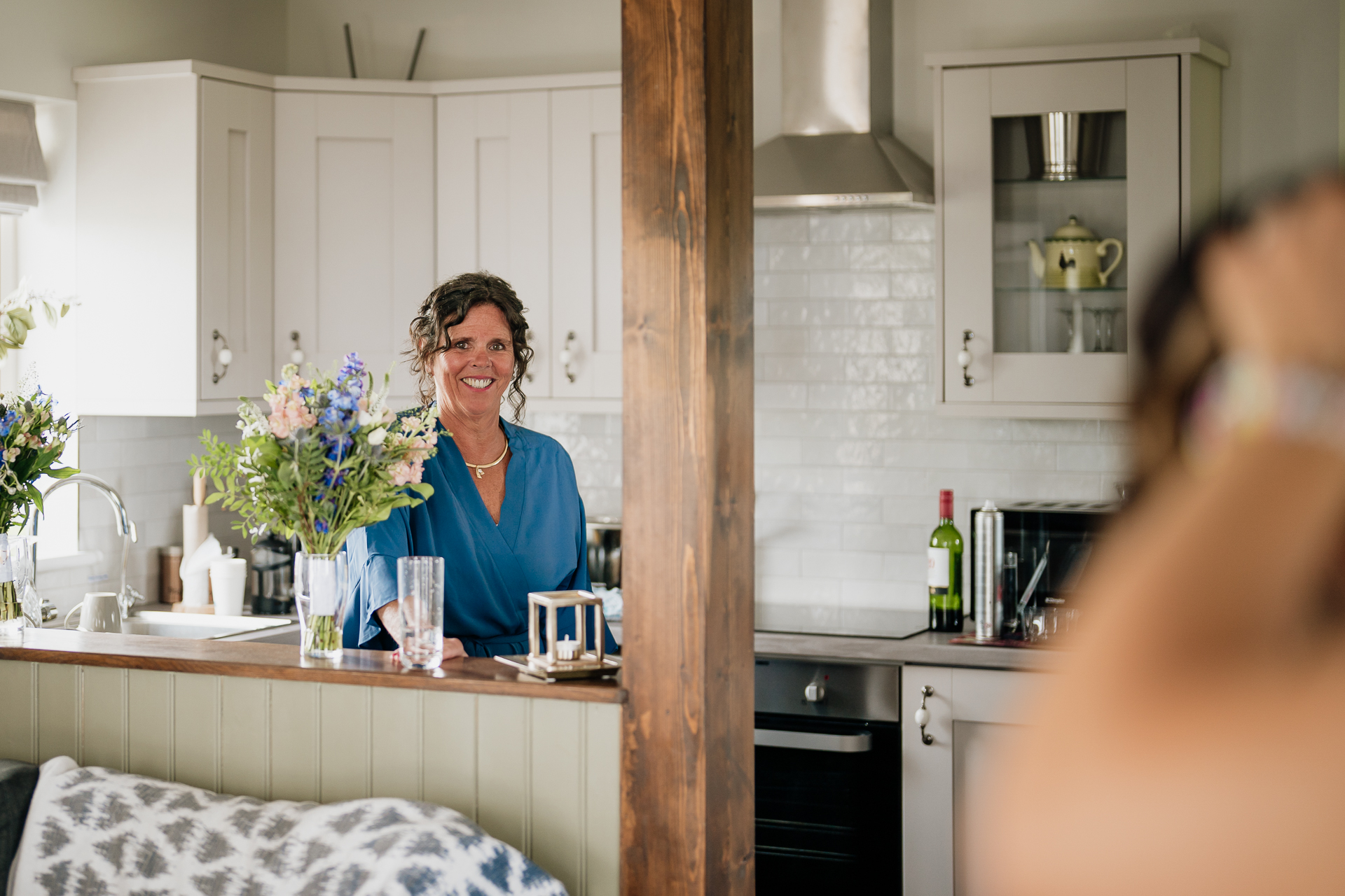 A person smiling in a kitchen