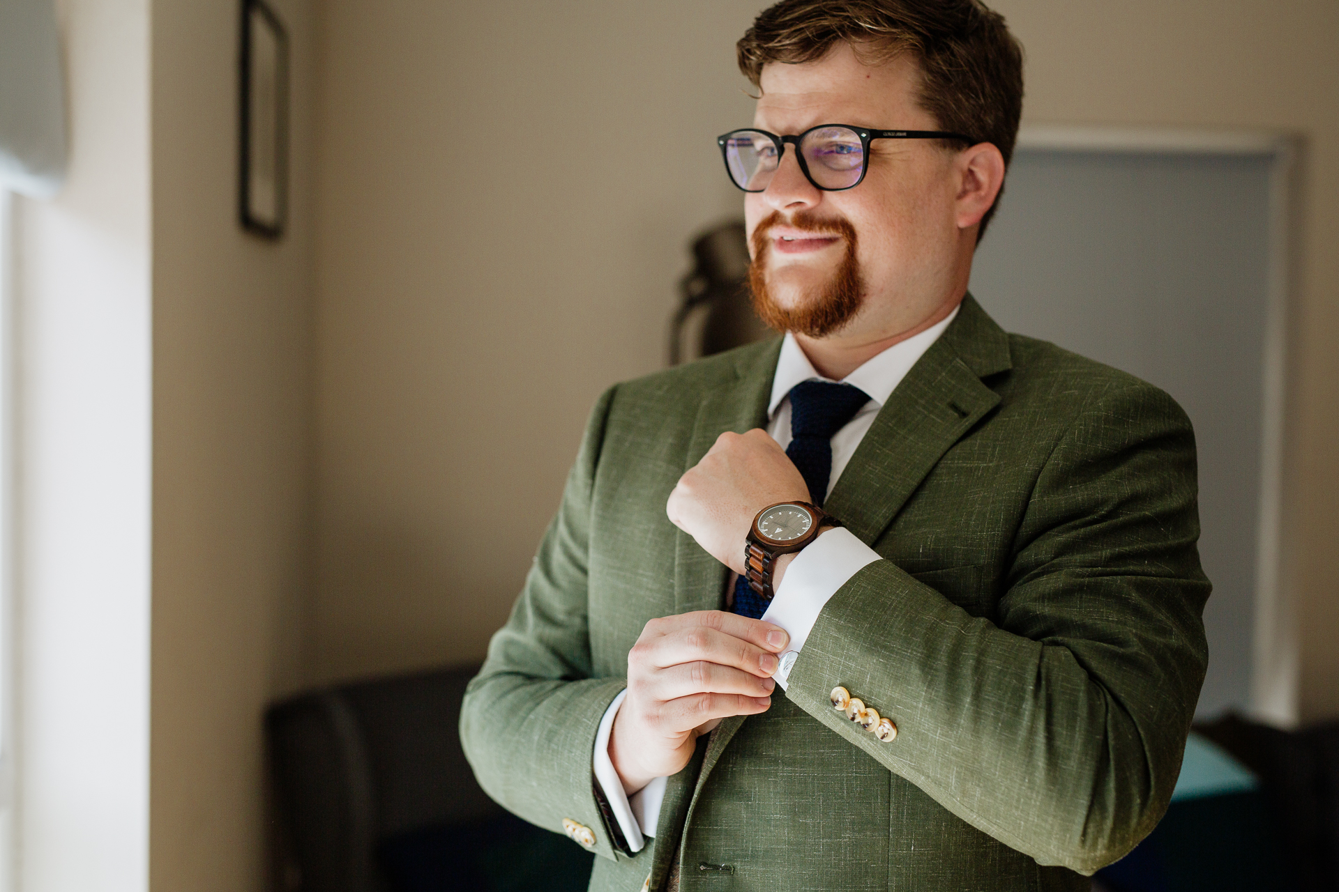 A man in a suit and tie holding a watch