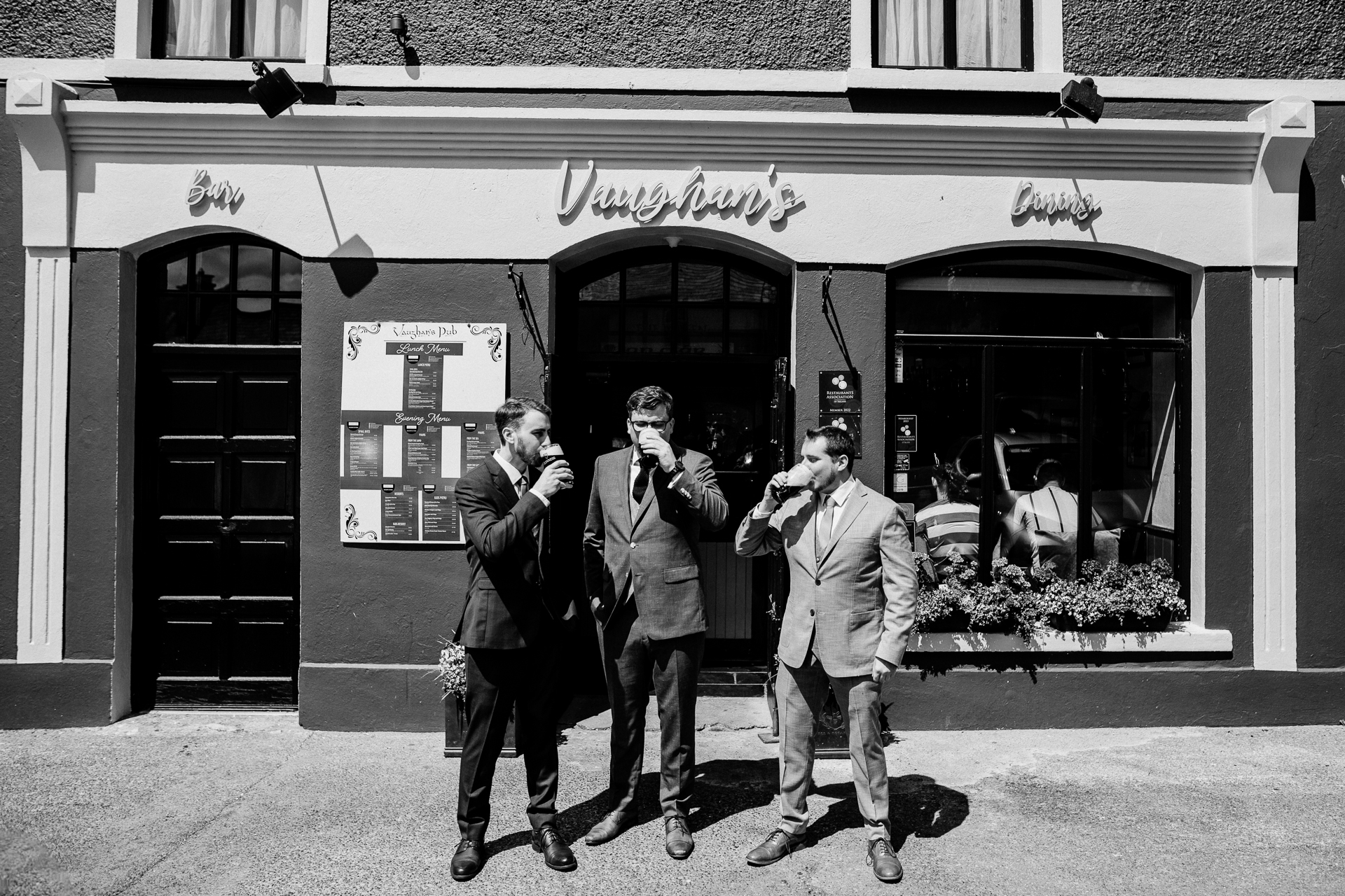 A group of men walking out of a store