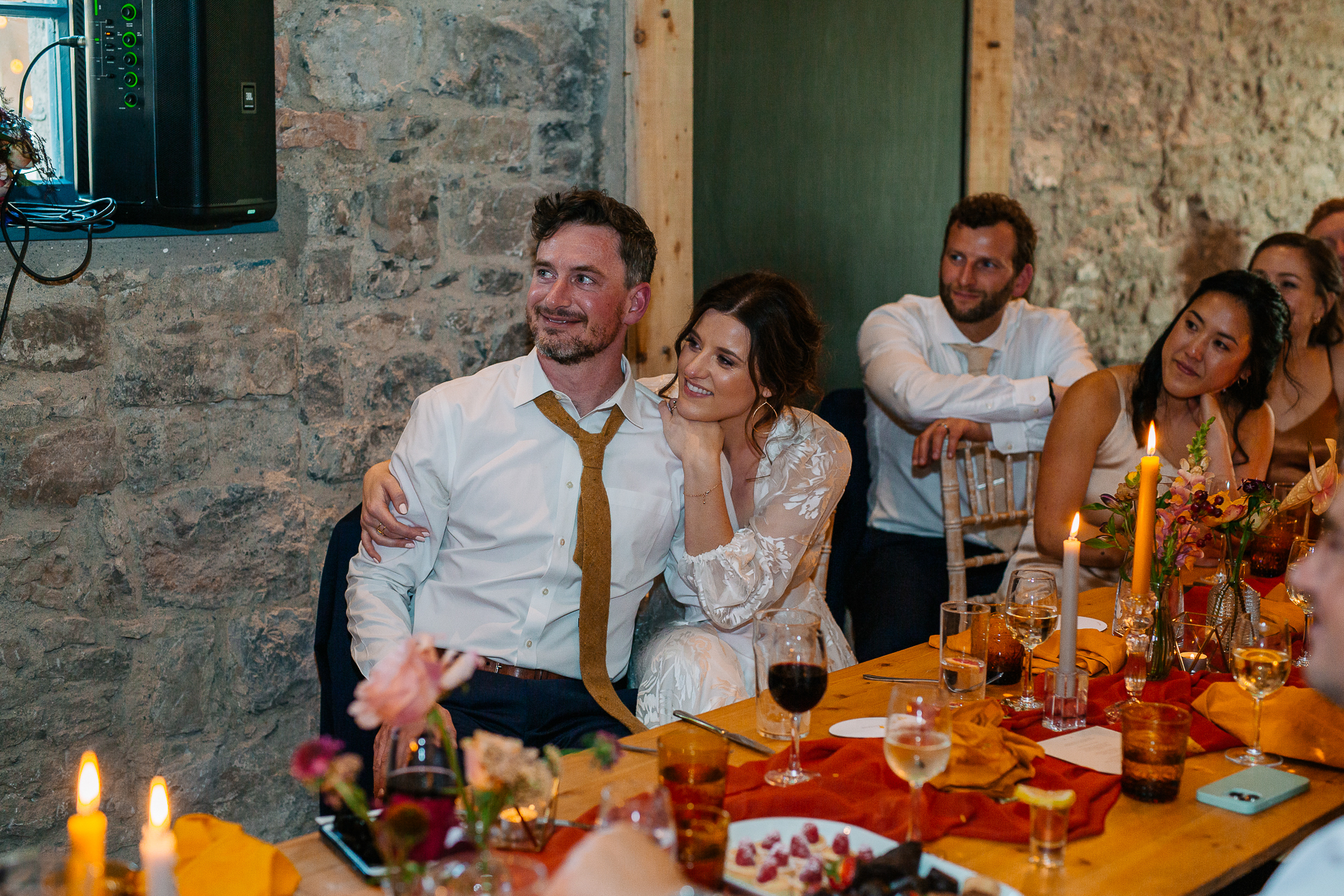 A group of people sitting at a table with food and drinks