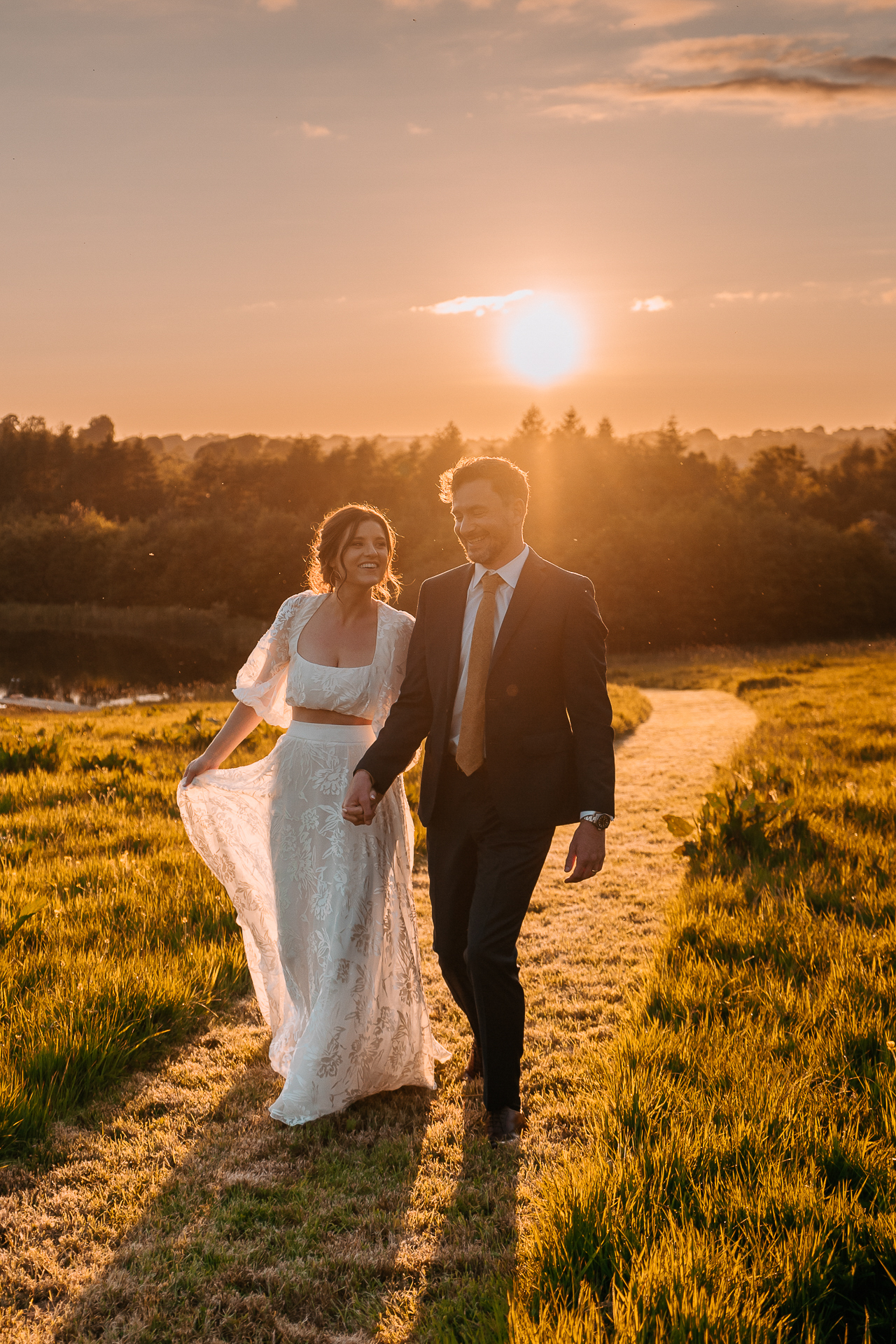 A man and woman posing for a picture in a field