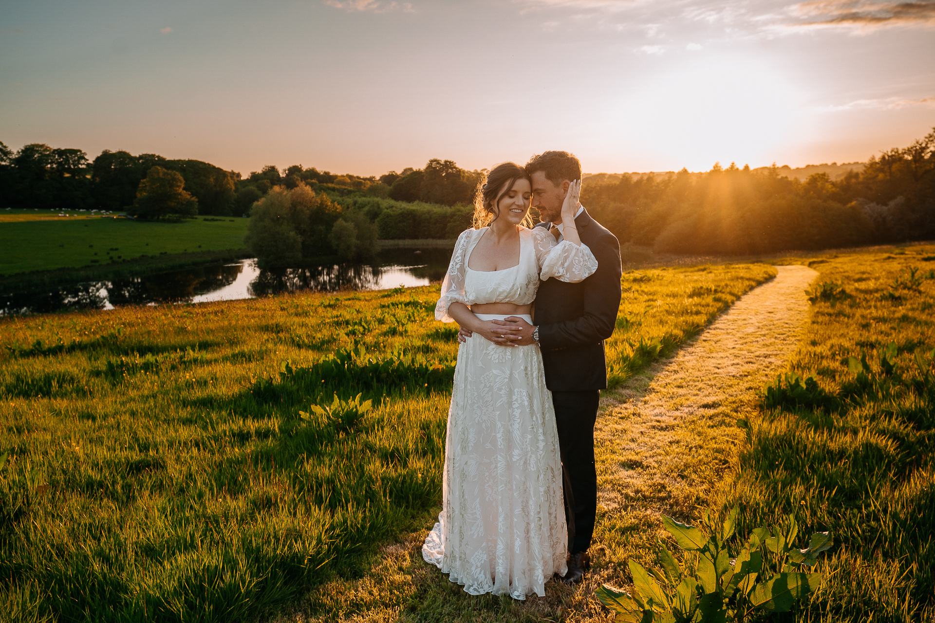 A man and woman posing for a picture in a field