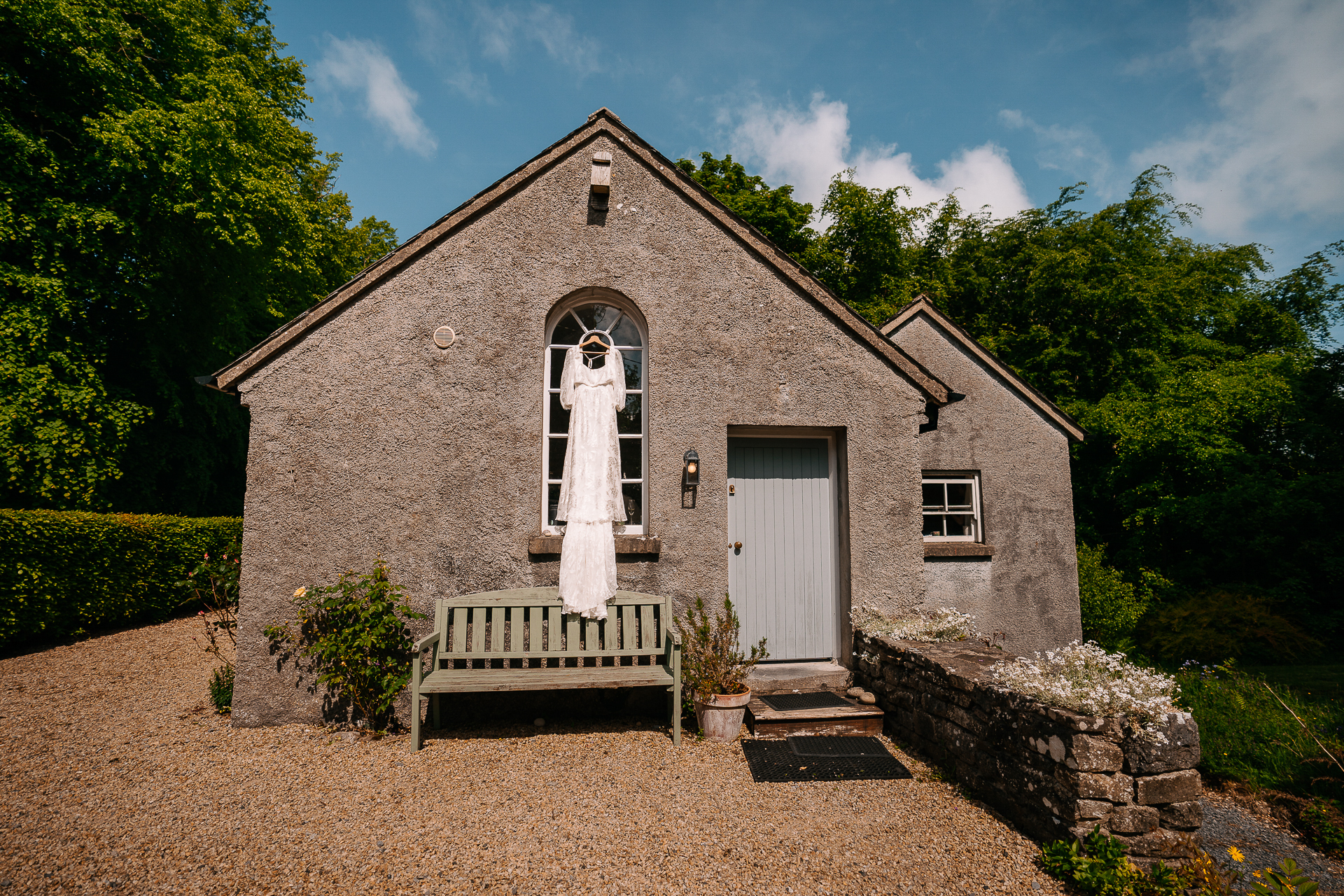 A stone building with a bench in front of it