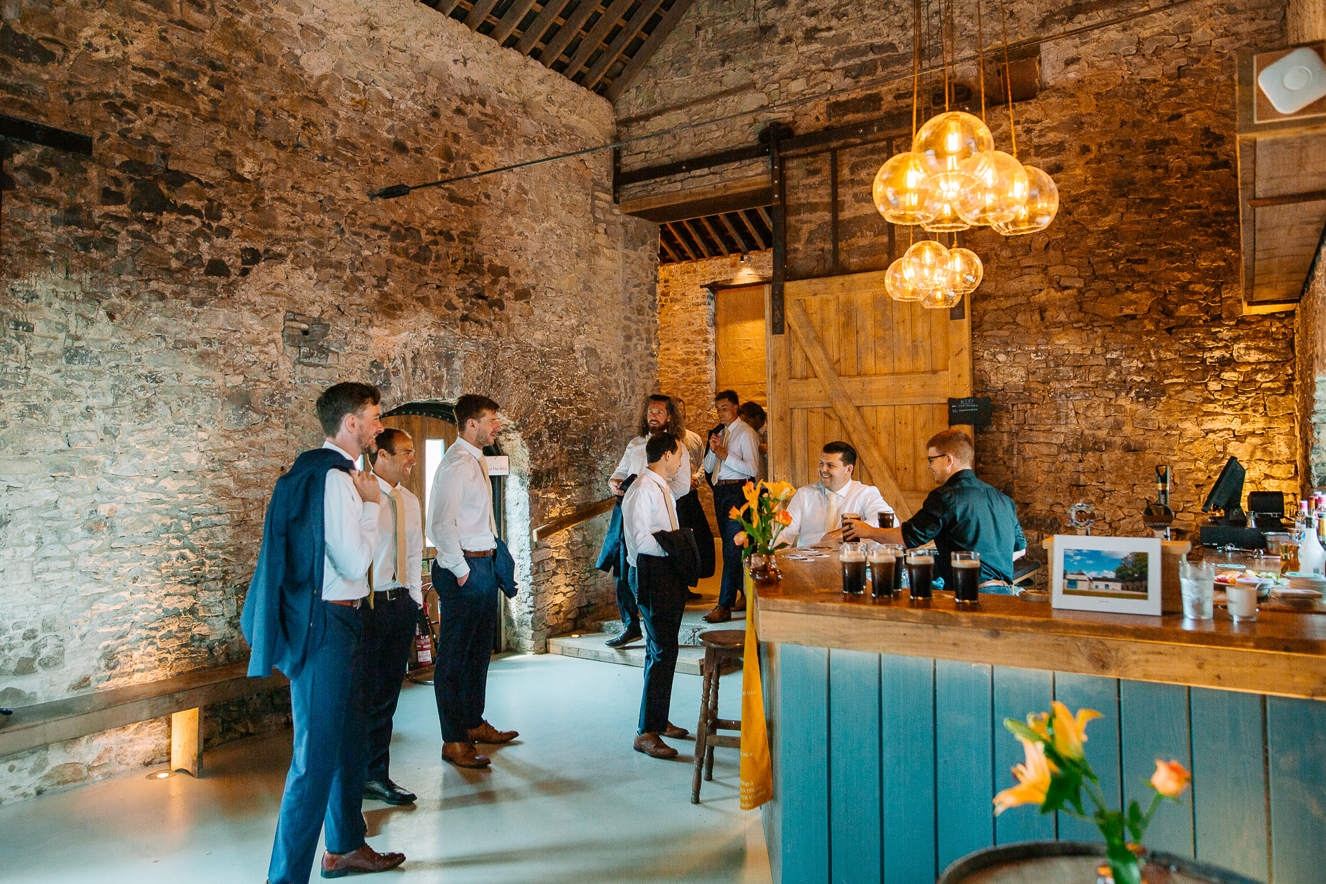 A group of people standing around a bar