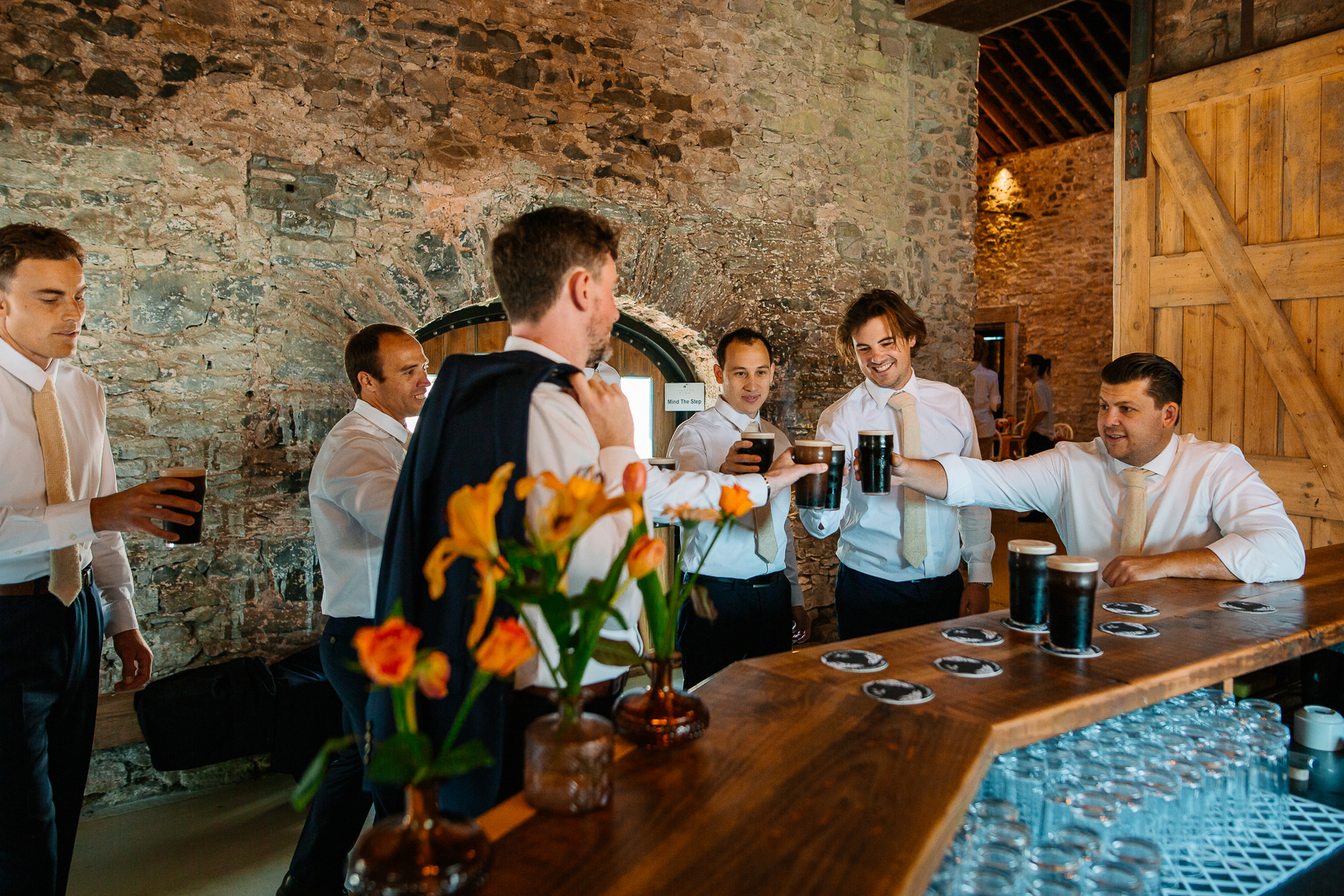 A group of people standing around a table with flowers