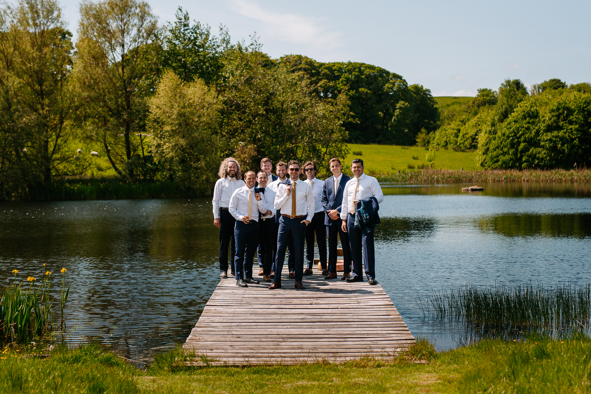 A group of people standing on a dock over a body of water