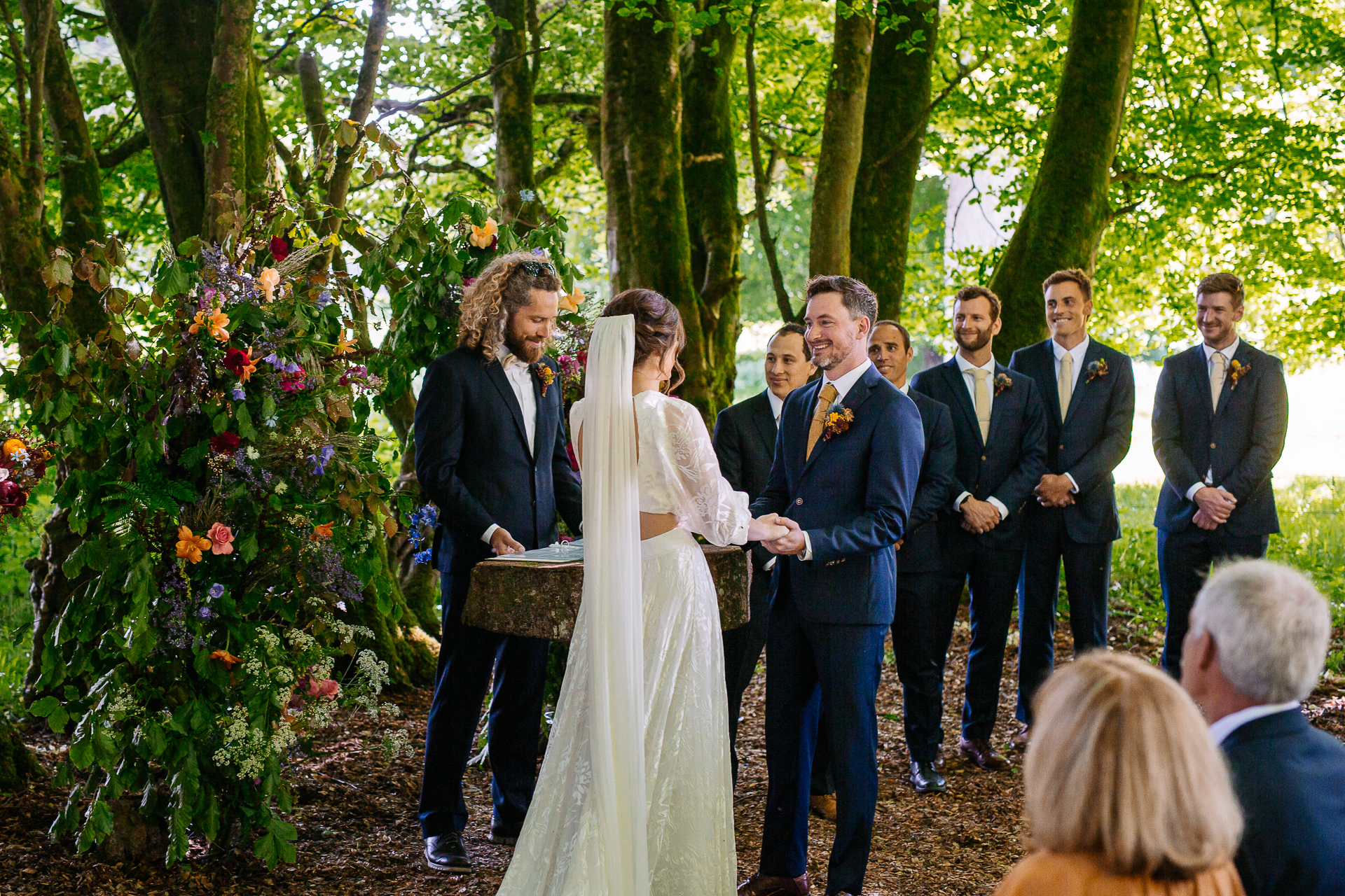 A group of people walking down a path in a forest