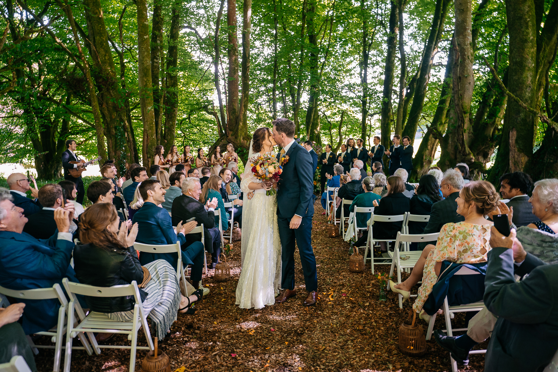 A man and woman walking down a aisle in front of a crowd of people