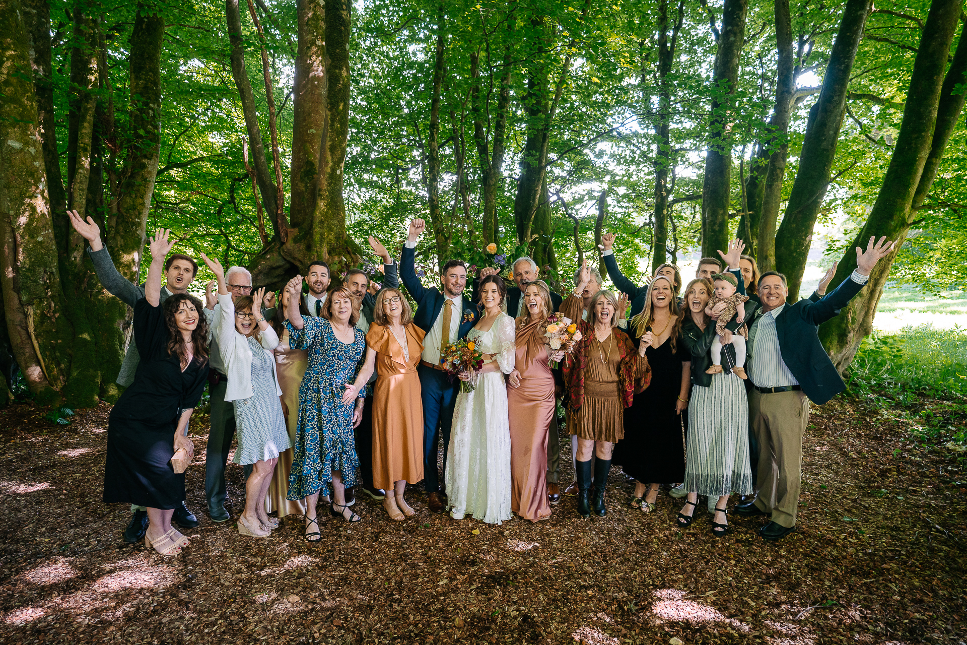 A group of people posing for a photo in the woods