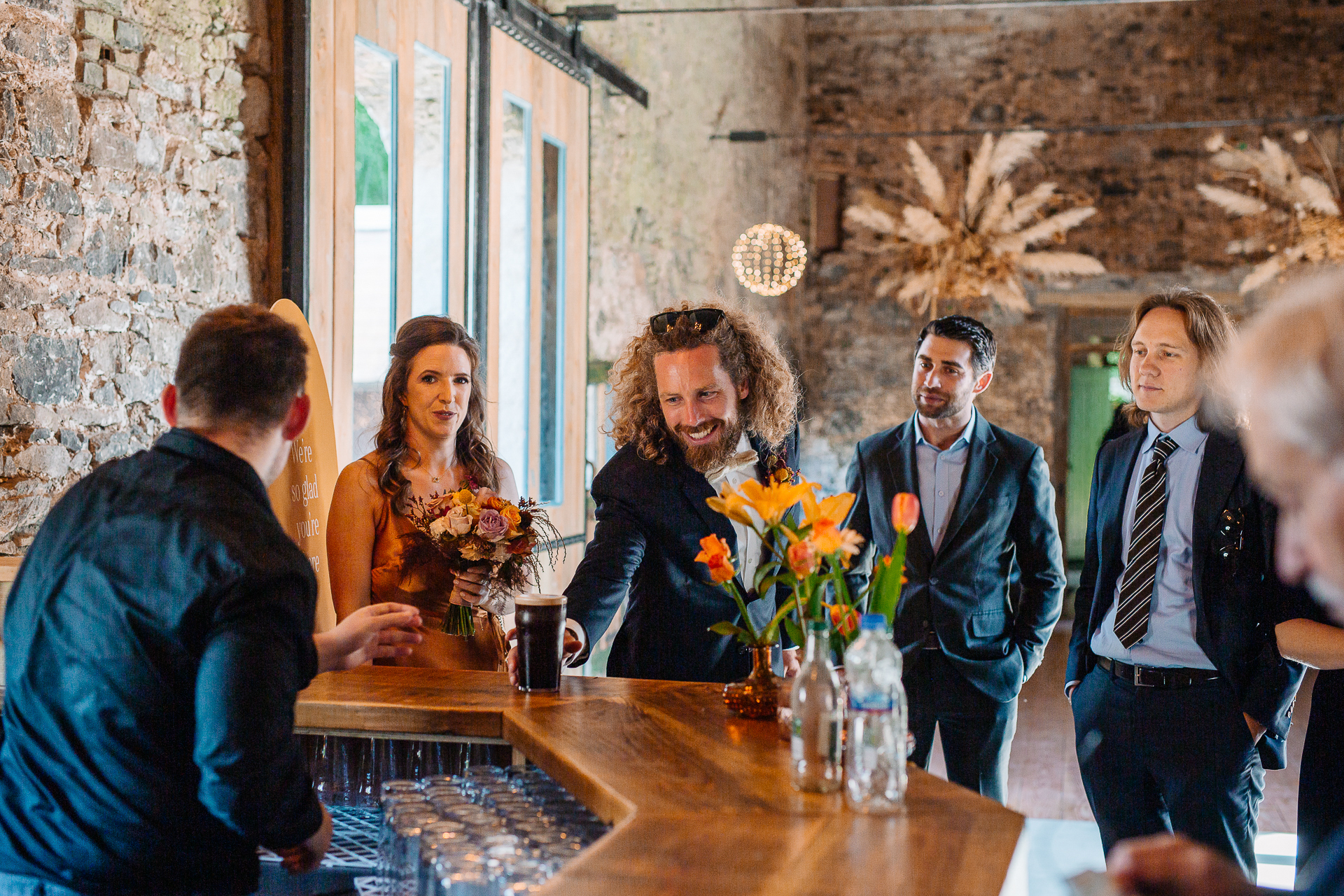 A group of people standing around a table with flowers